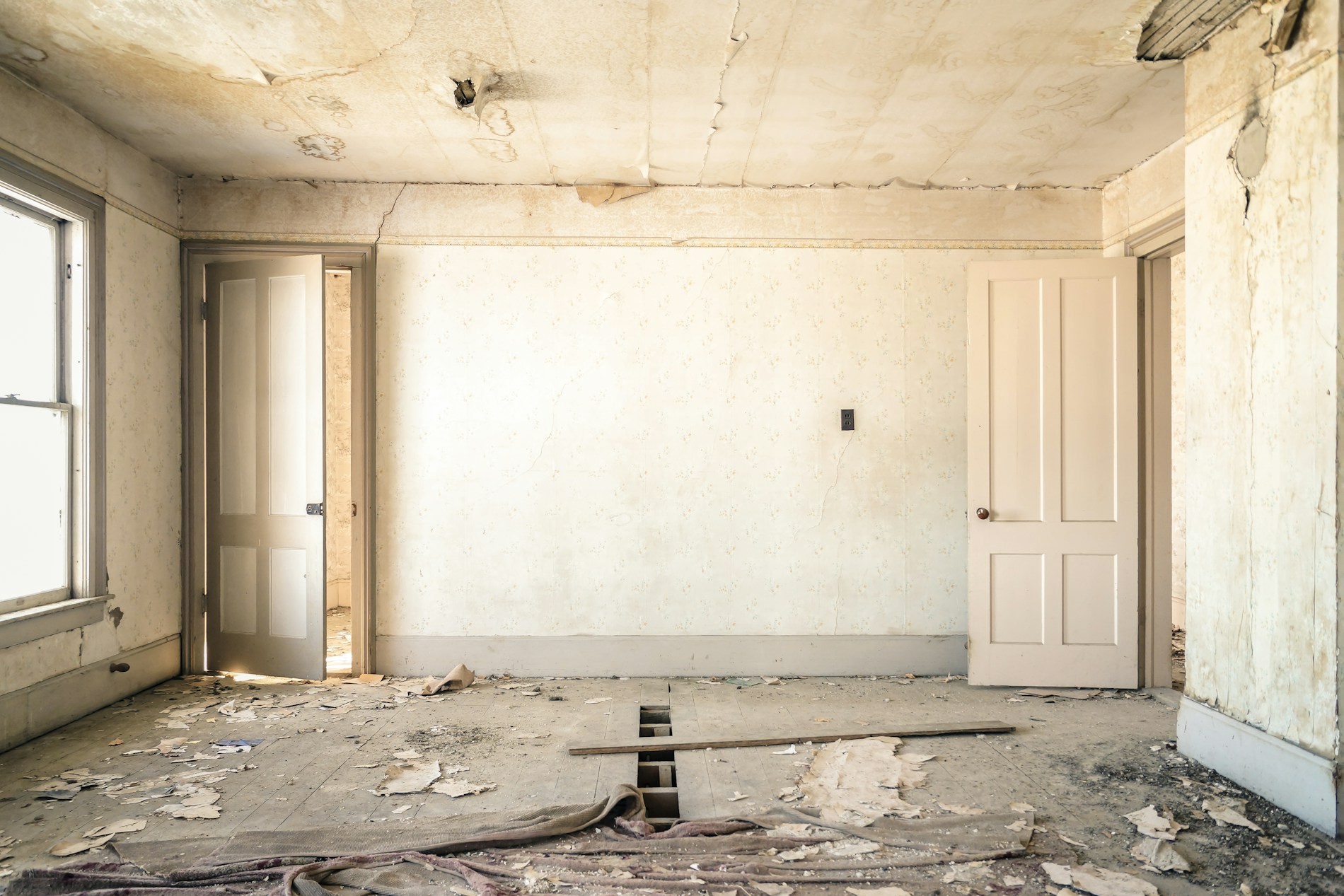 Empty room stripped back to bare concrete walls during renovation