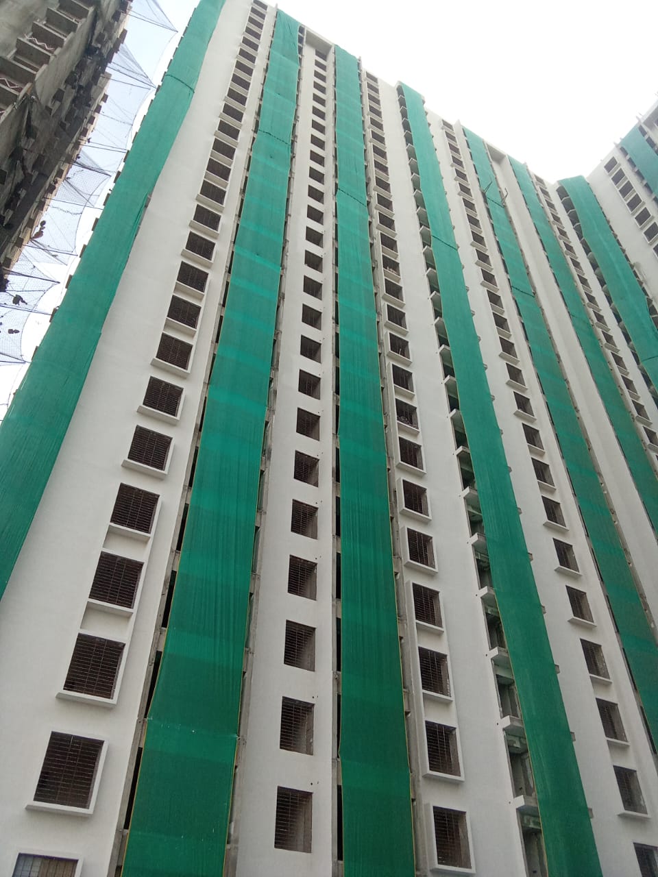 Safety net installation at high-rise construction site 