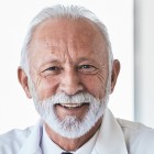 Senior male physician headshot highlighting experience in radiology and healthcare staffing.