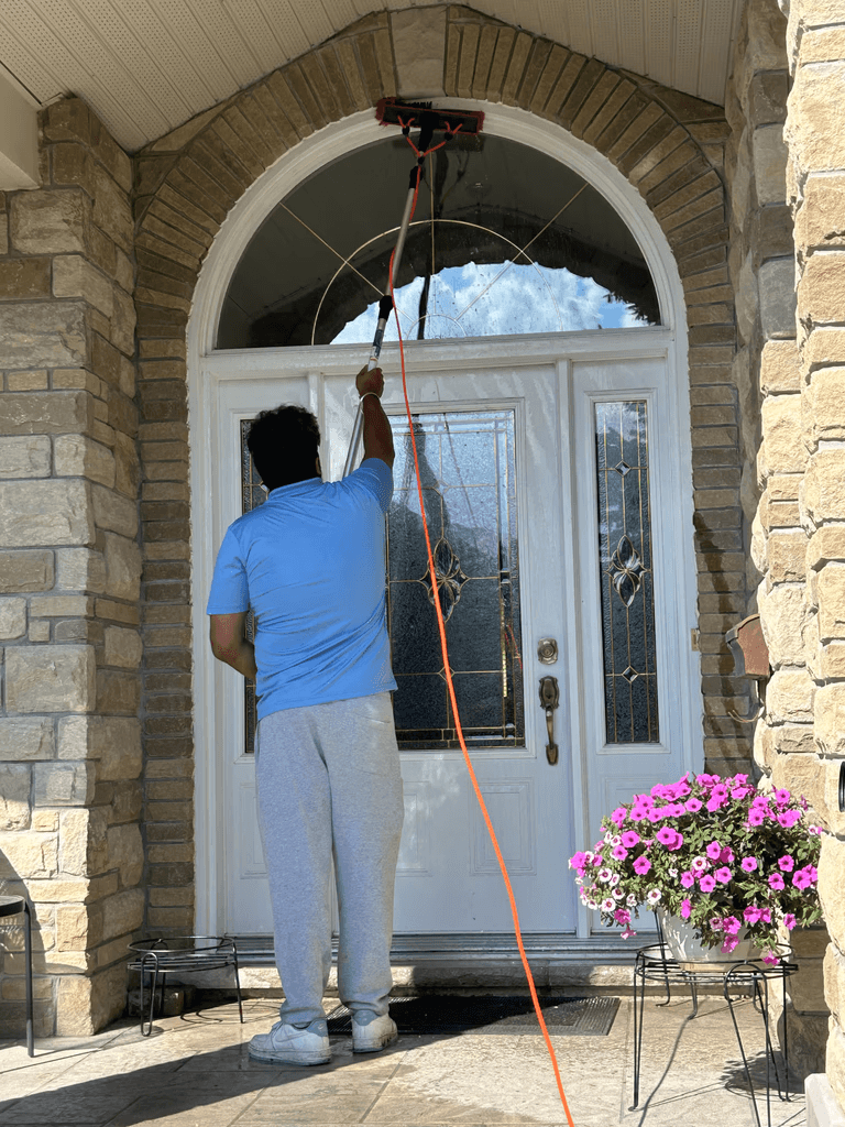 AquaPure staff member cleaning front-porch windows