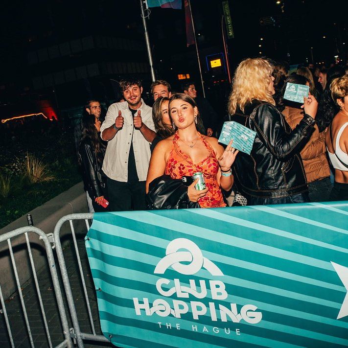 woman standing in line with a ticket entering a festival