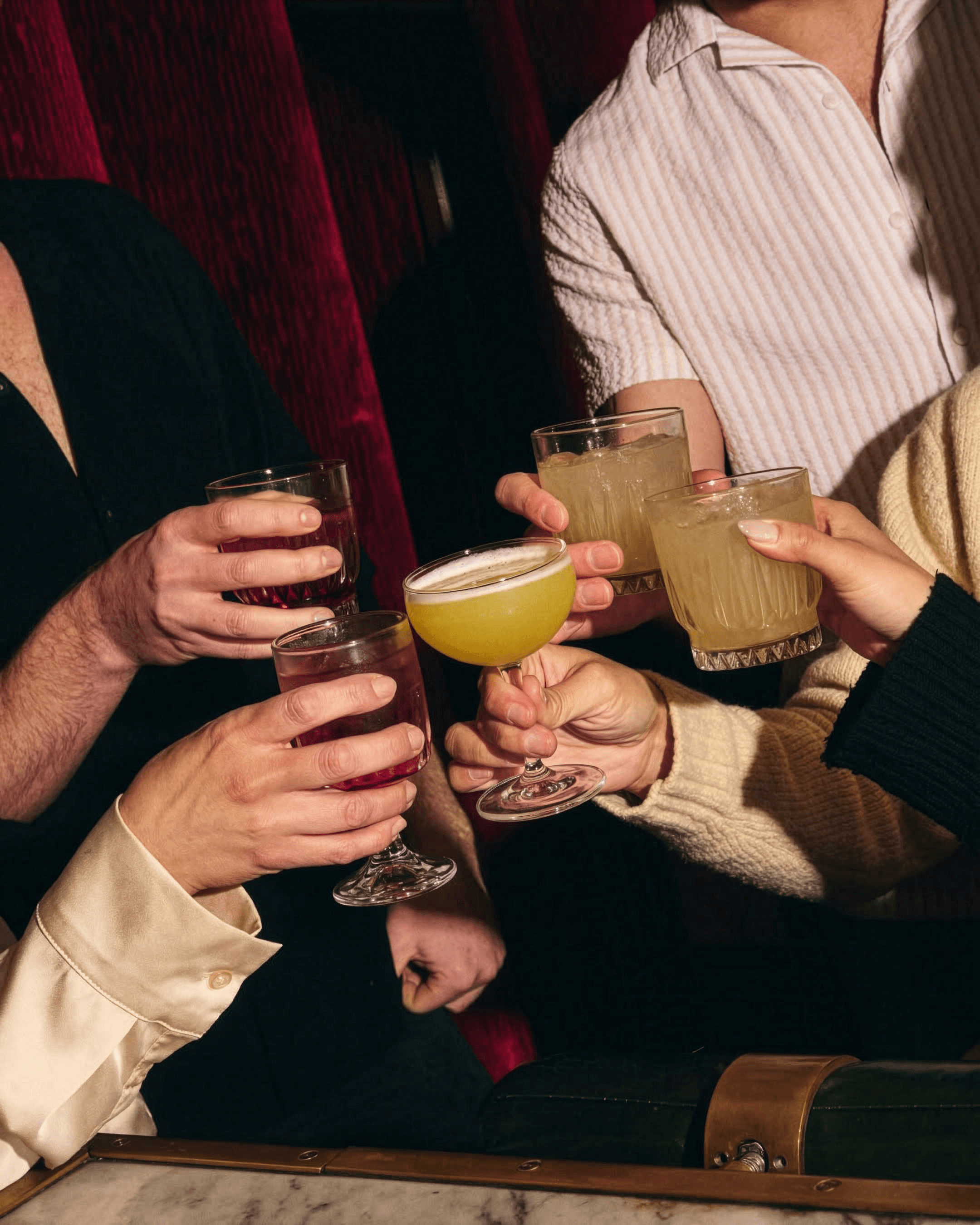 Theater goers toasting cocktails