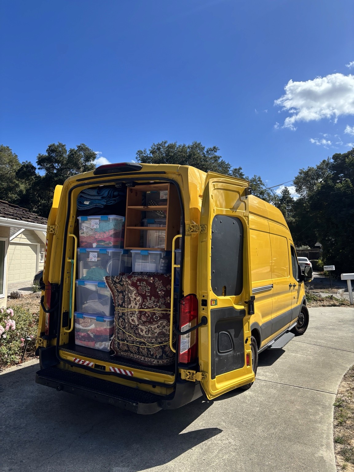 Loaded yellow moving van with furniture and bins secured for a local studio or one-bedroom move.