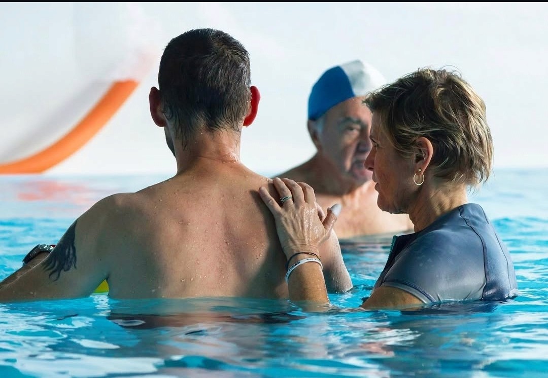 Female doctor discussing over tablet pc with patient standing in hospital
