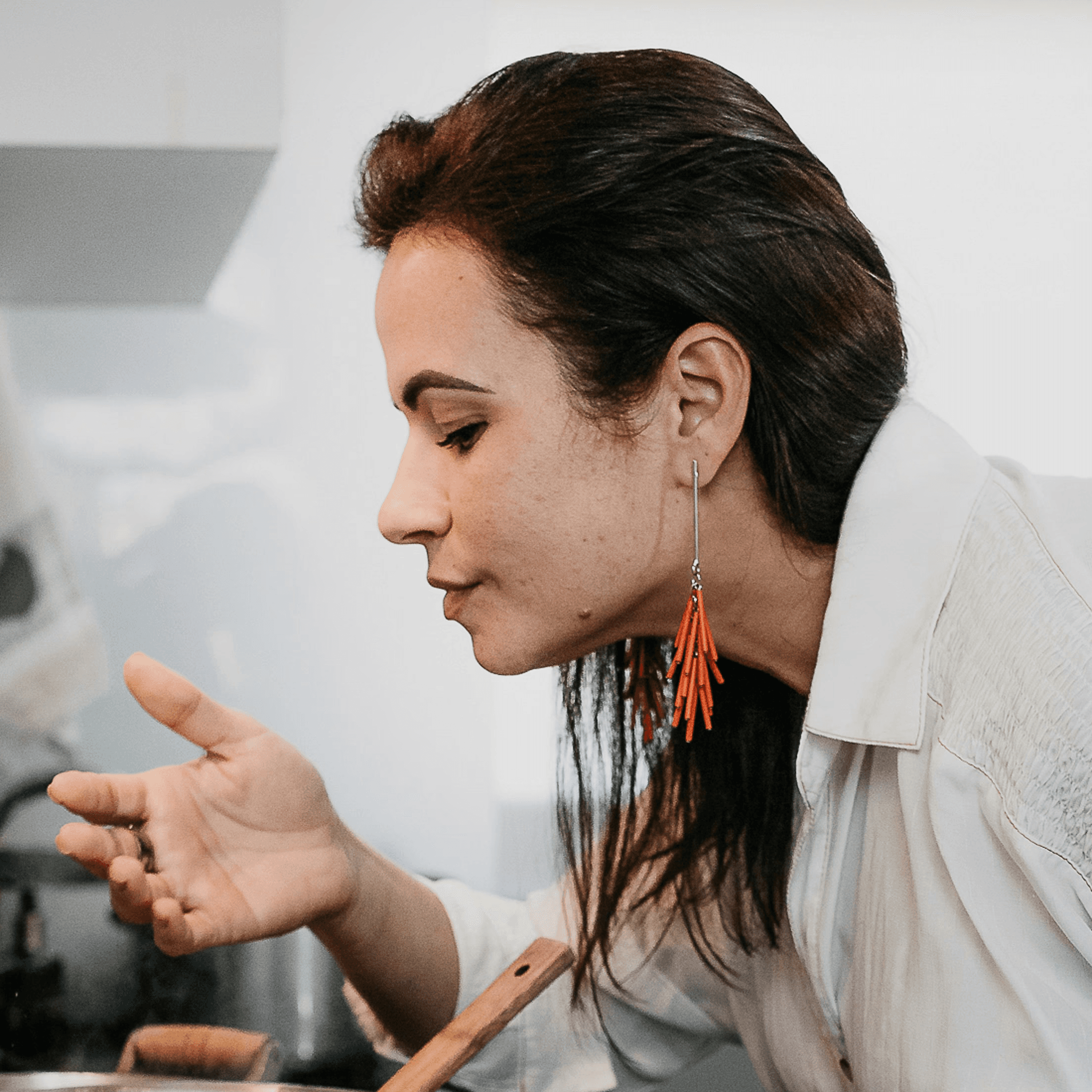 woman in white robe holding chopsticks