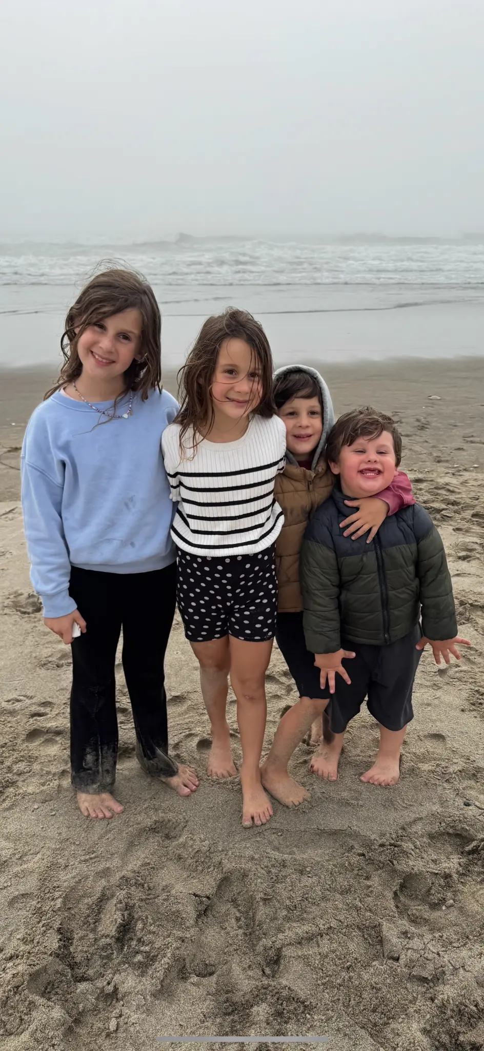 A picture of the four children on a beach