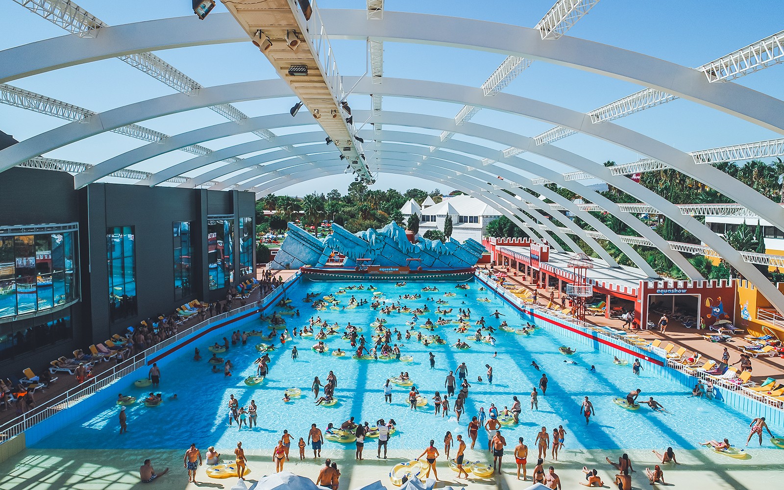 Visitors enjoying the wave pool at Aquashow Water Park, Portugal.