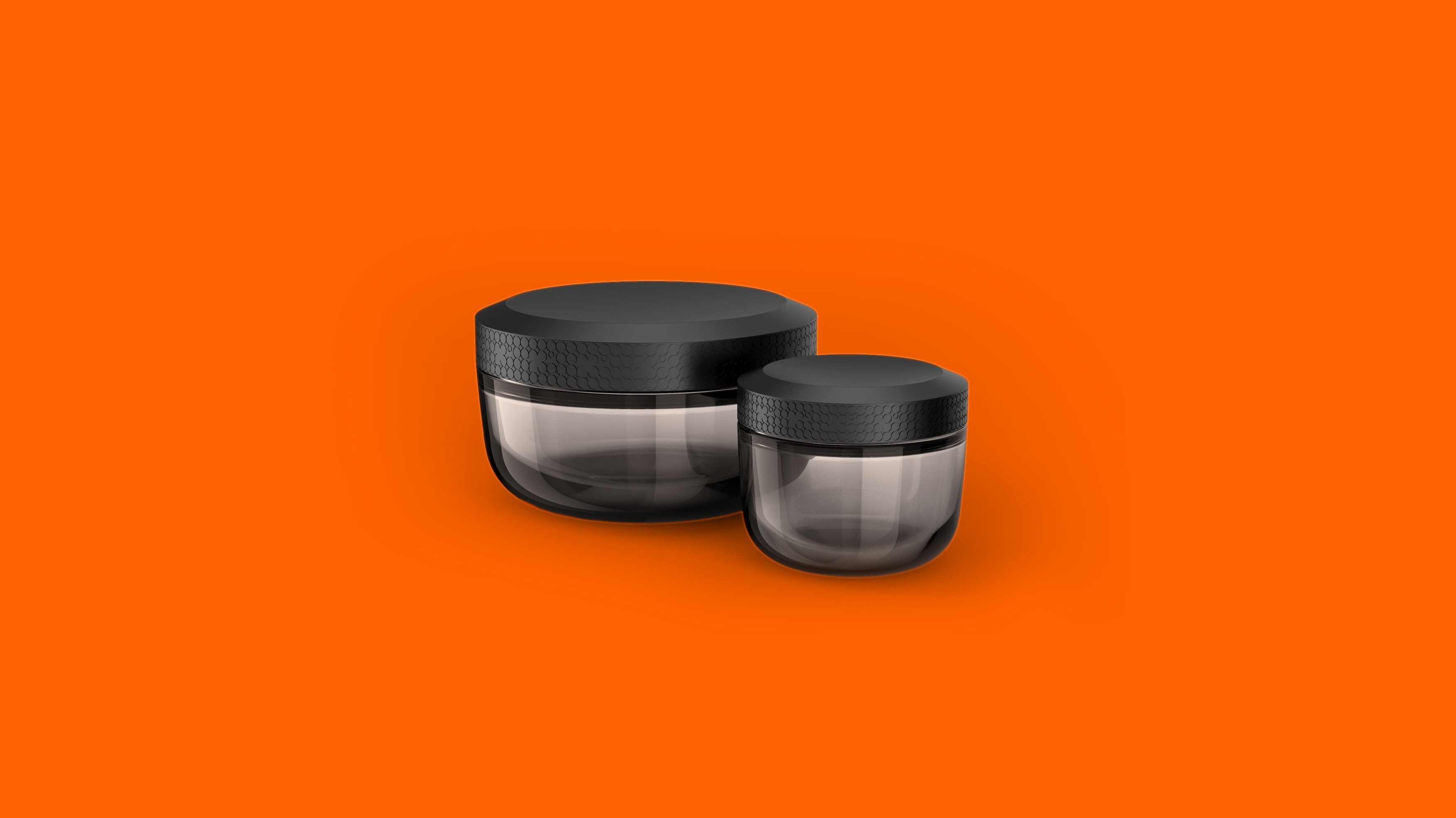 Sleek black cannabis grinder designed by a product development firm, showcased against a bold orange backdrop. Modern and functional product design.