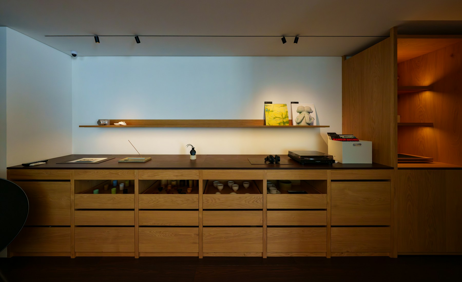 Long timber sideboard with drawers beneath a floating shelf