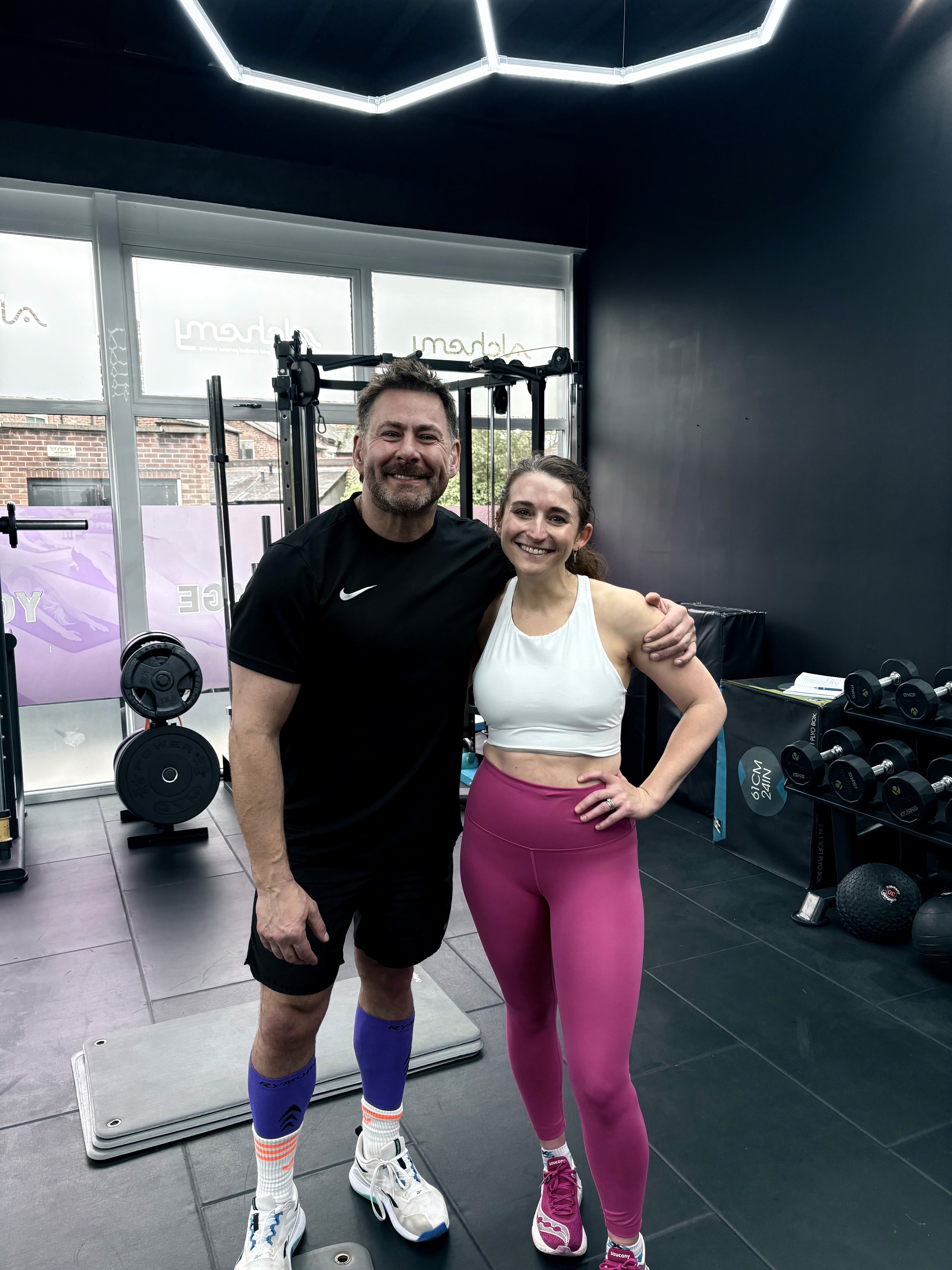 Fitness director Rufus posing with a client of Alchemy Personal Training. 