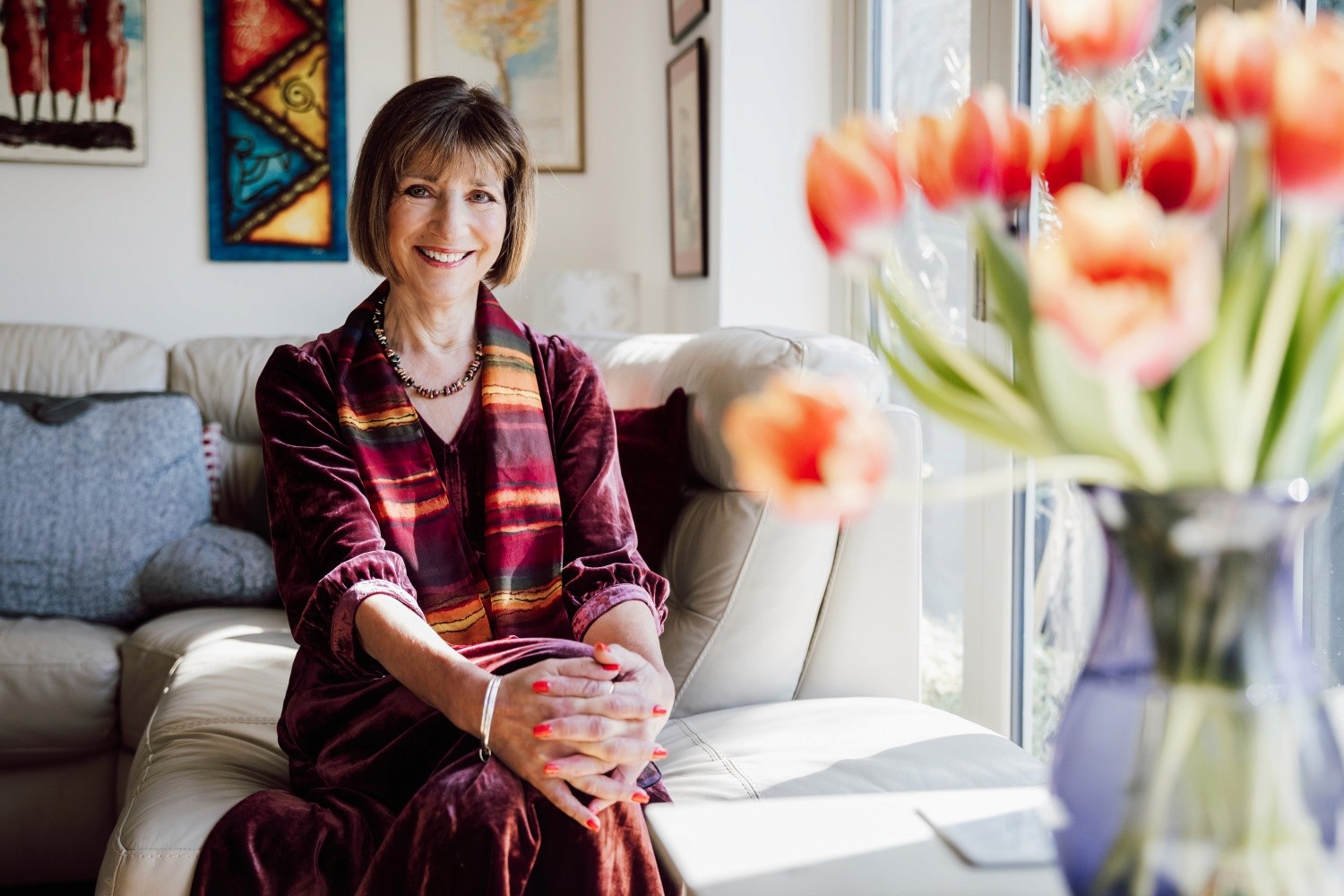 Izzy, smiling lady with vase of tulips