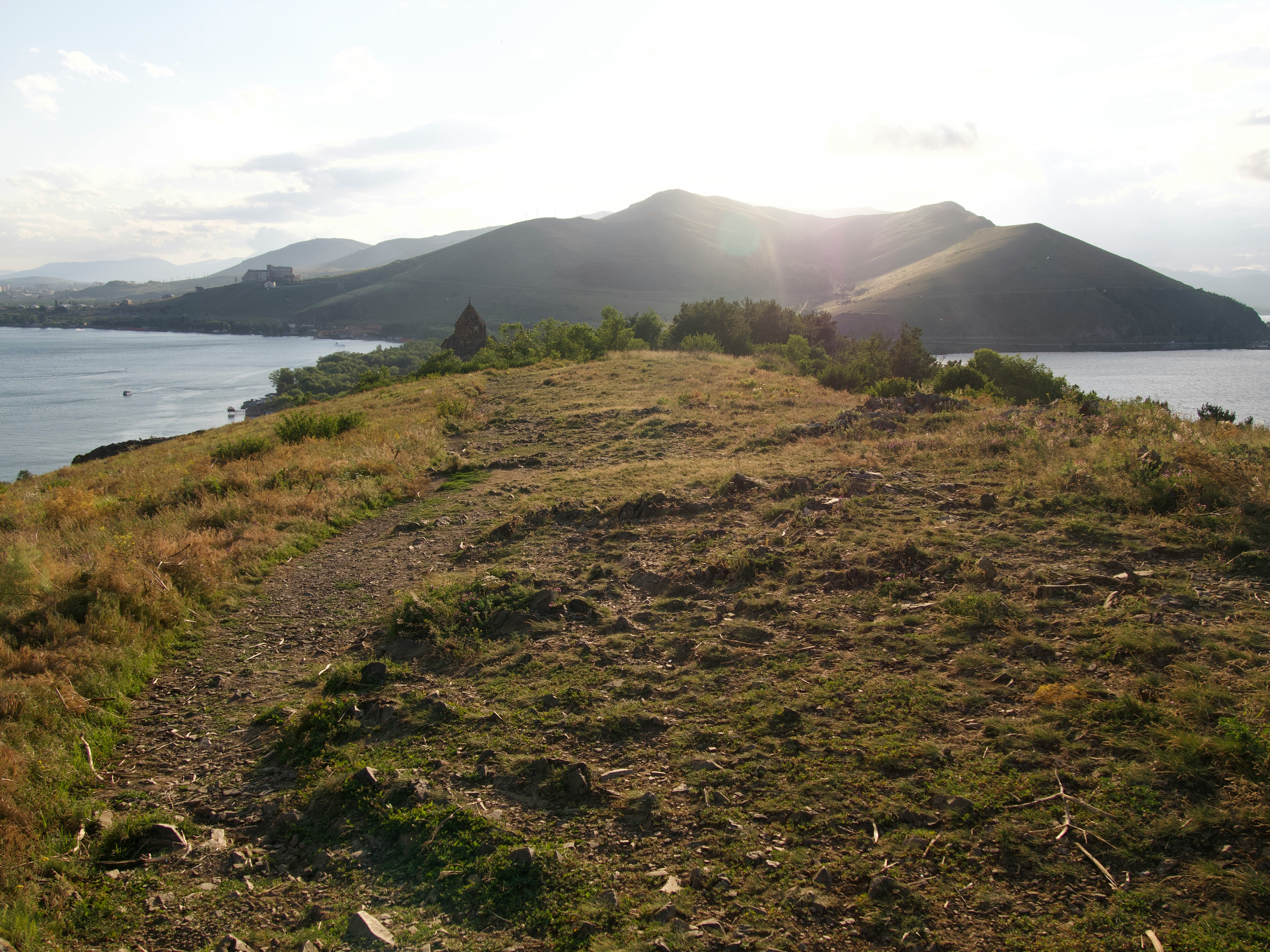 a grassy area next to a body of water