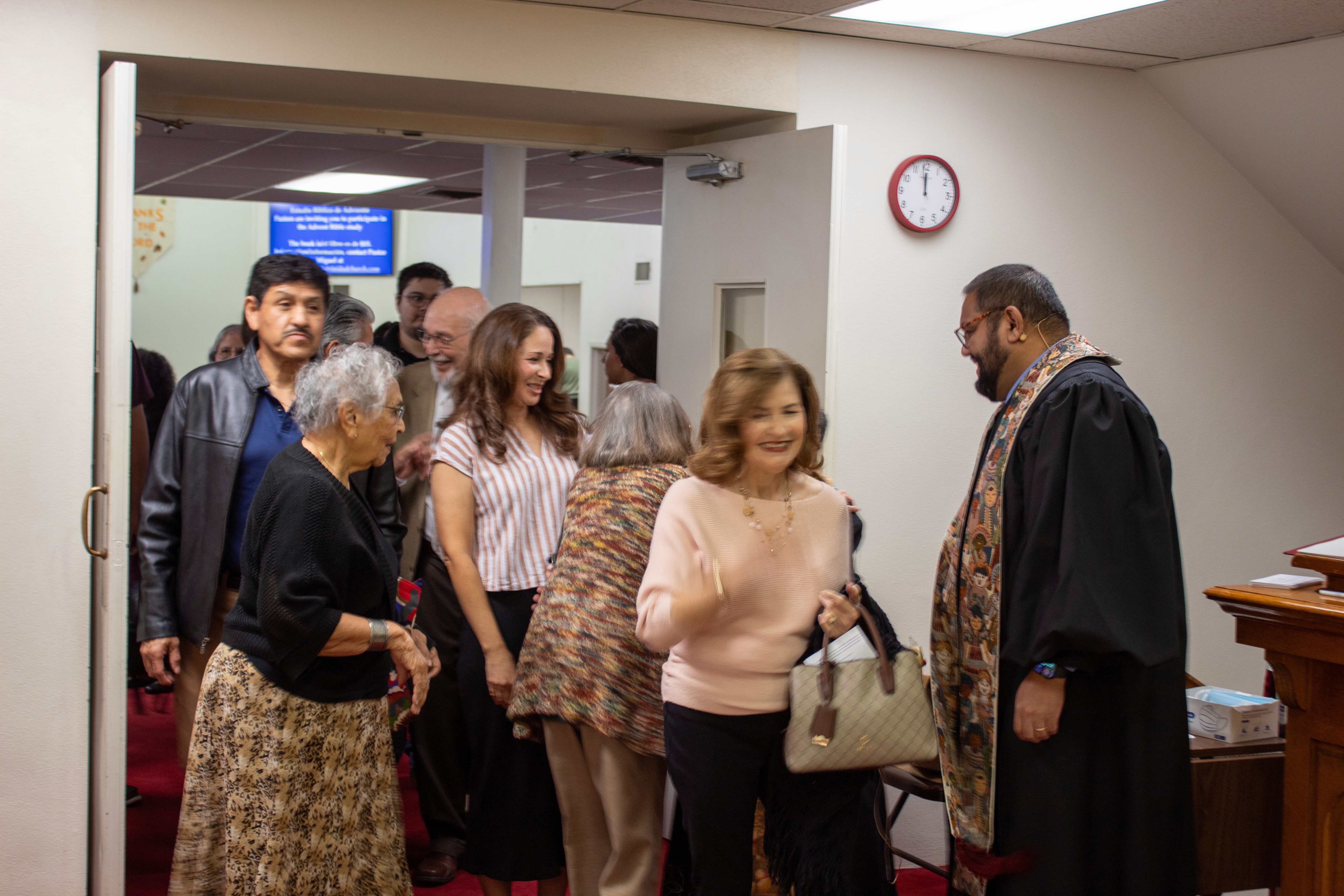 group of people walking through a door