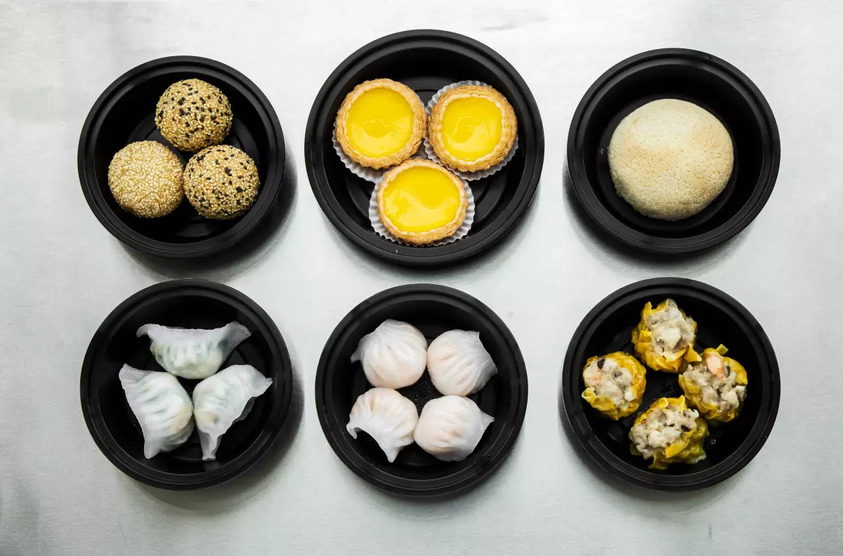 Dishes at ixlb, from top left: sesame balls; baked egg custard tart, French cha siu bao; and bottom from left, shrimp and chives dumpling; har gow; siu mai. (Ricardo DeAratanha / Los Angeles Times)