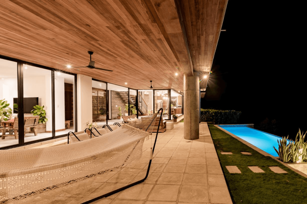 Covered outdoor living terrace framing panoramic Pacific Ocean views at LV House by Hurtado Arquitectos in San Juan del Sur, Nicaragua.