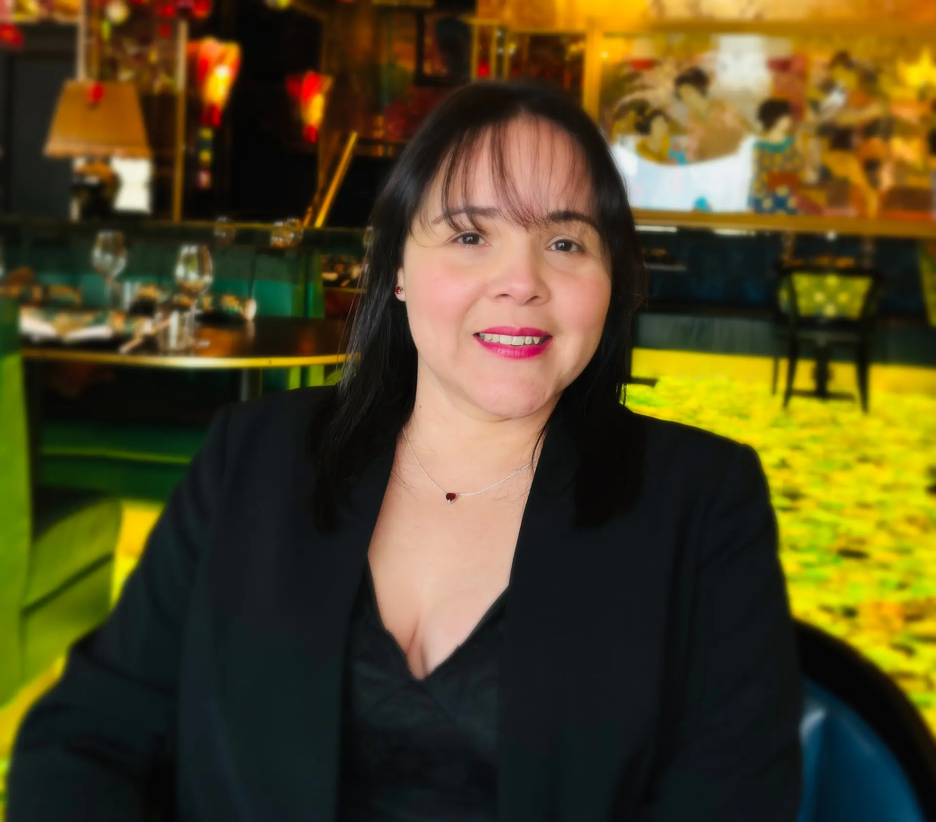 Suyin M, founder of Slow Knife Design, photographed in a cinematic portrait inside a modern, artistic interior.