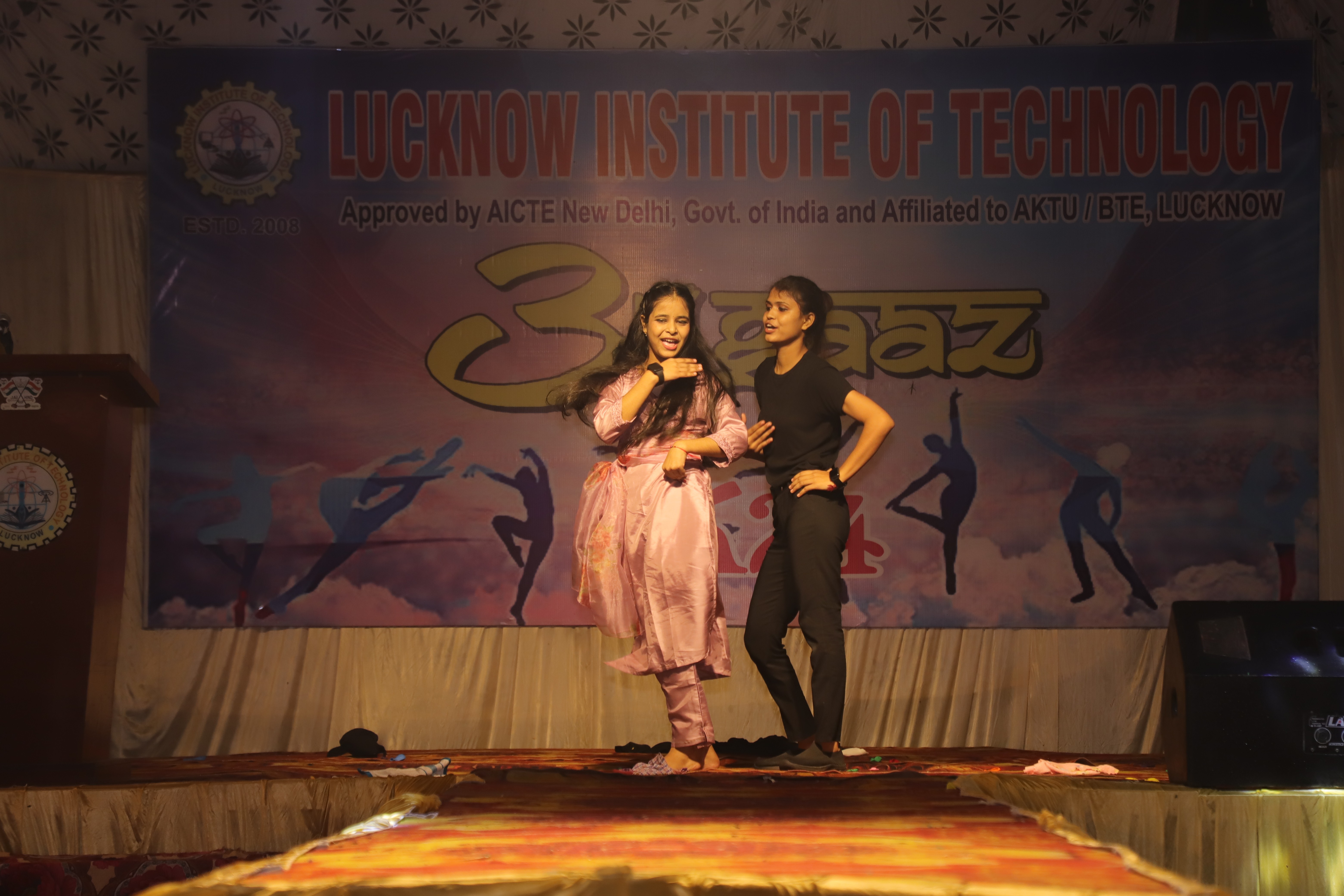 man standing in front of people sitting beside table with laptop computers