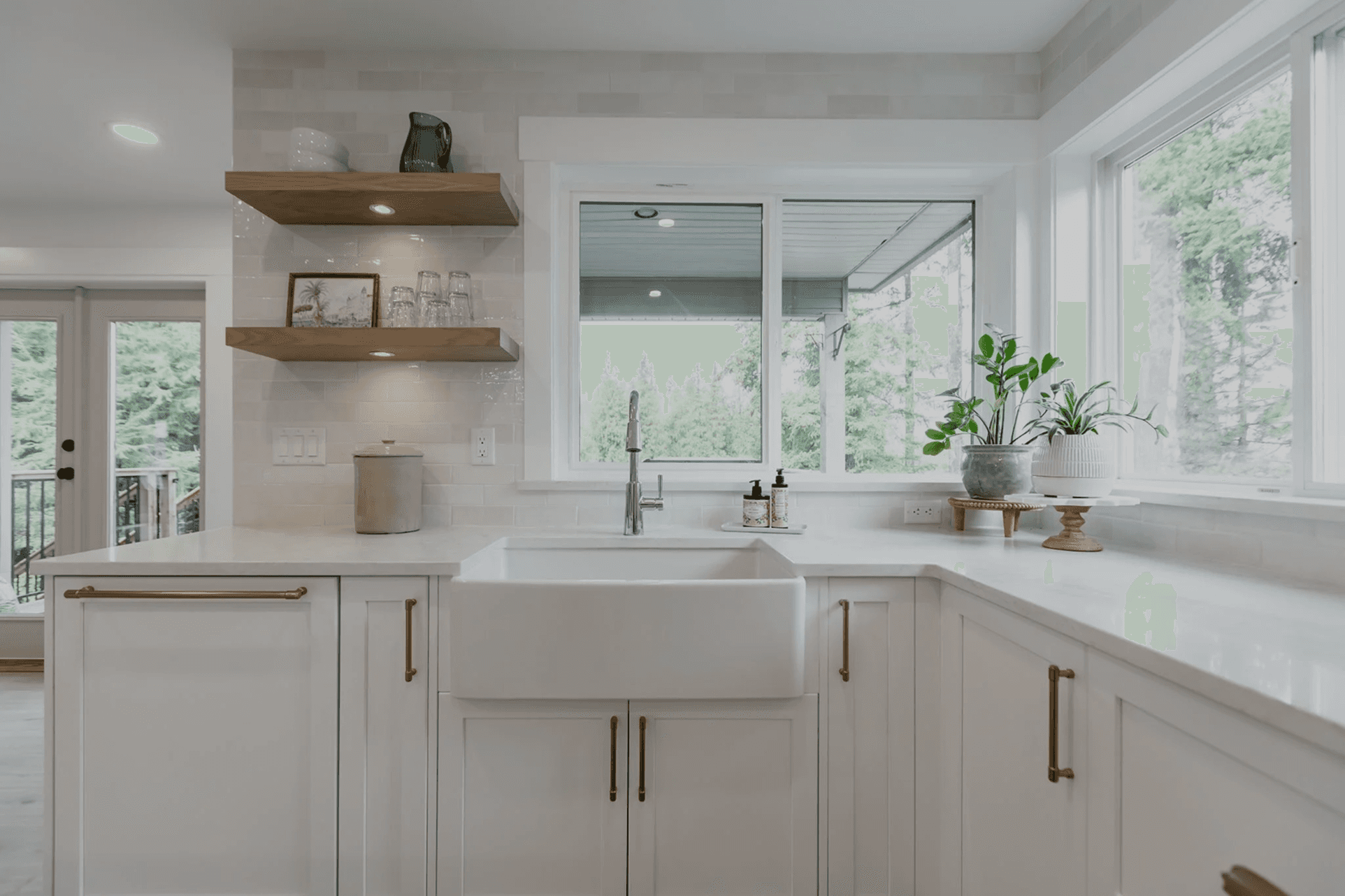 Bright modern kitchen with white shaker cabinets, quartz countertops, and a central island