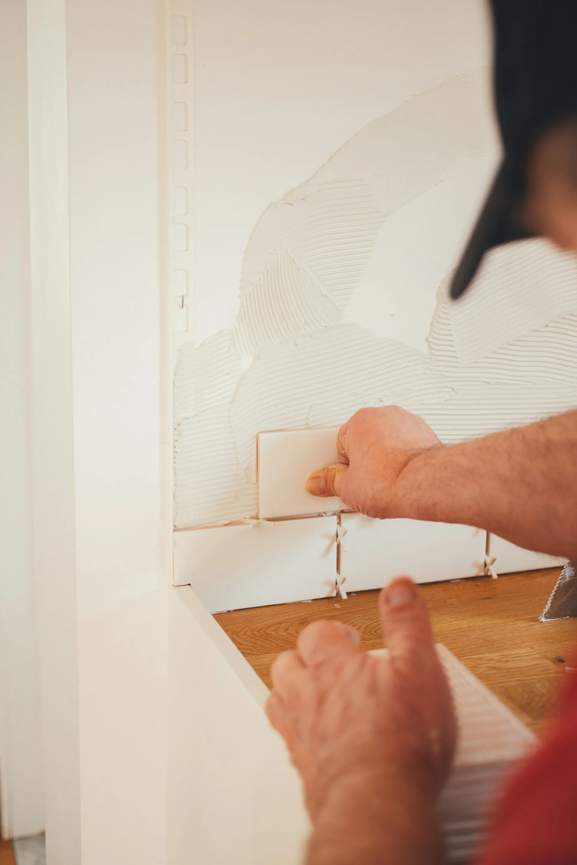 Professional installing wooden wall panels with precise alignment