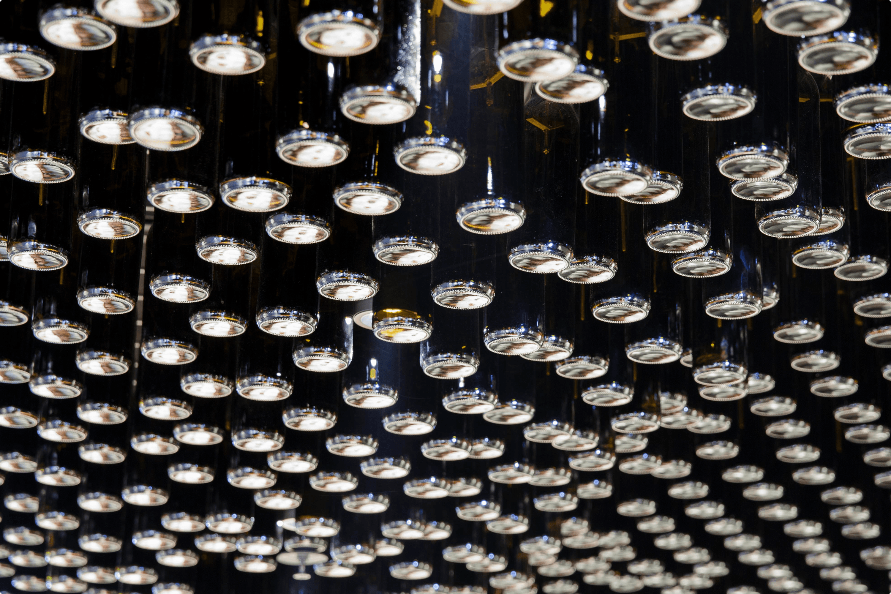 Ceiling lights with chrome rims on black tubes.
