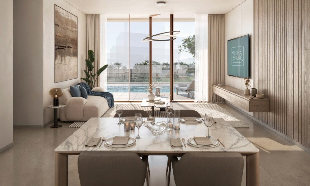Chic living room at Flora Shore Beachfront Residences, presenting a breathtaking view of the urban skyline.