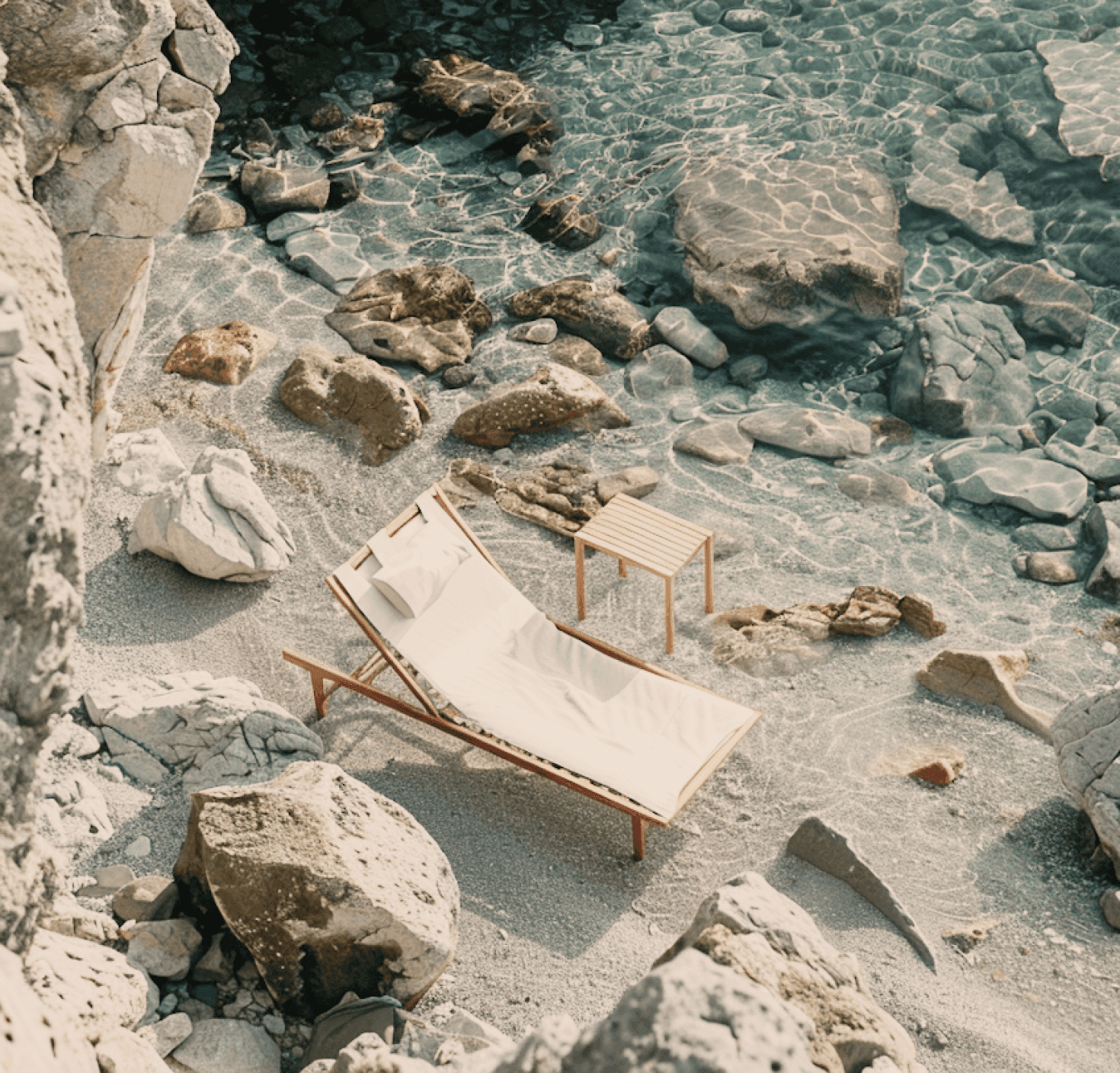 Secluded coastal nook with a lounge chair by crystal-clear water and sunlit rocks.