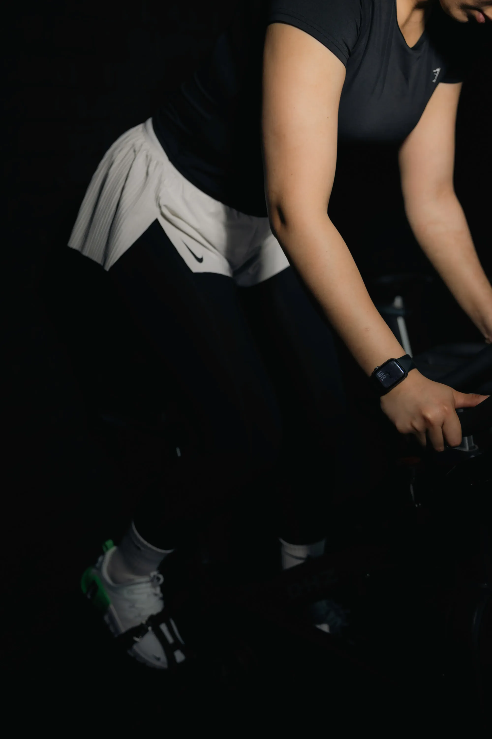 A woman lifting a barbell in a gym