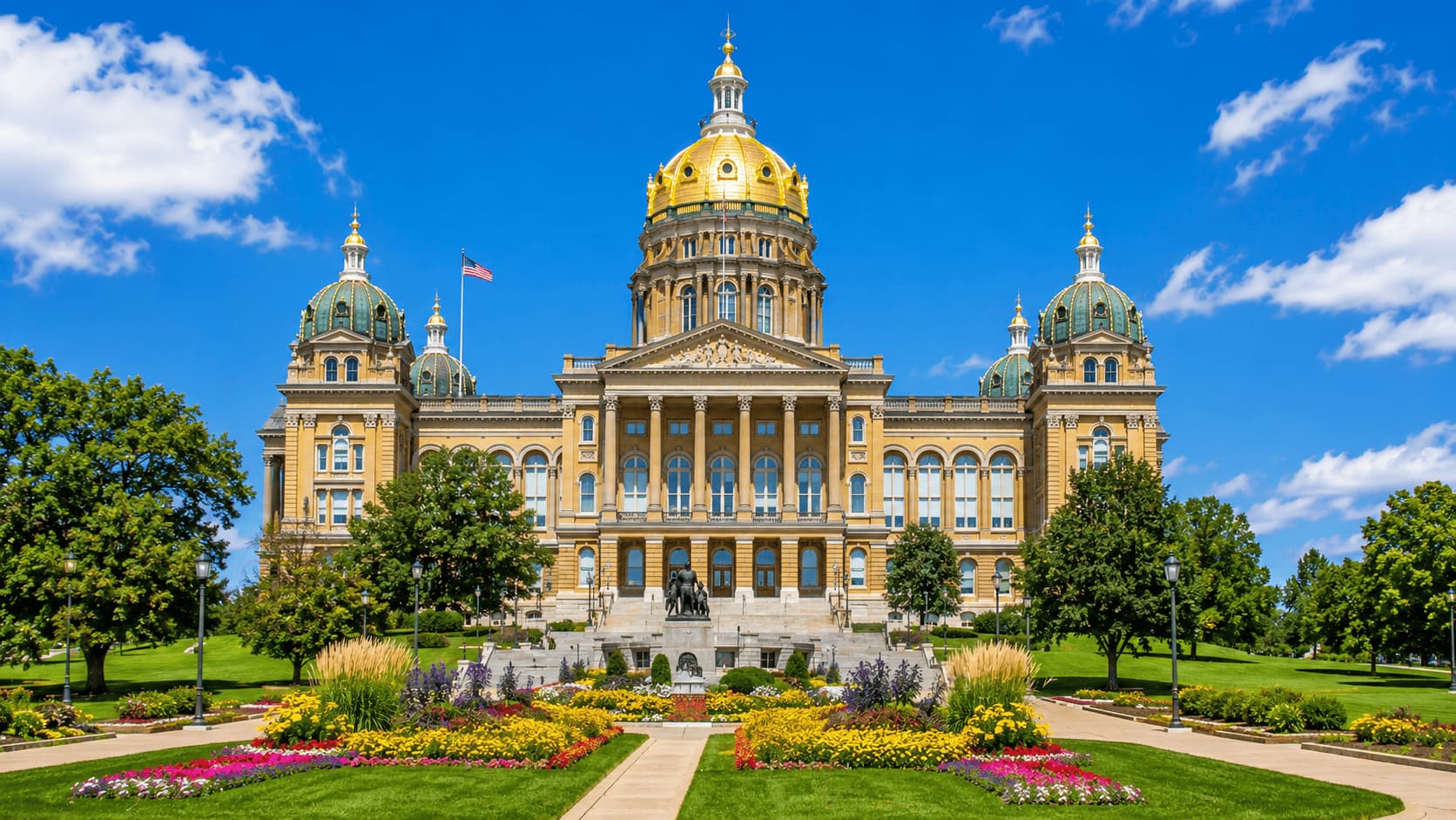 Iowa State Capitol in Des Moines with golden dome and landscaped gardens