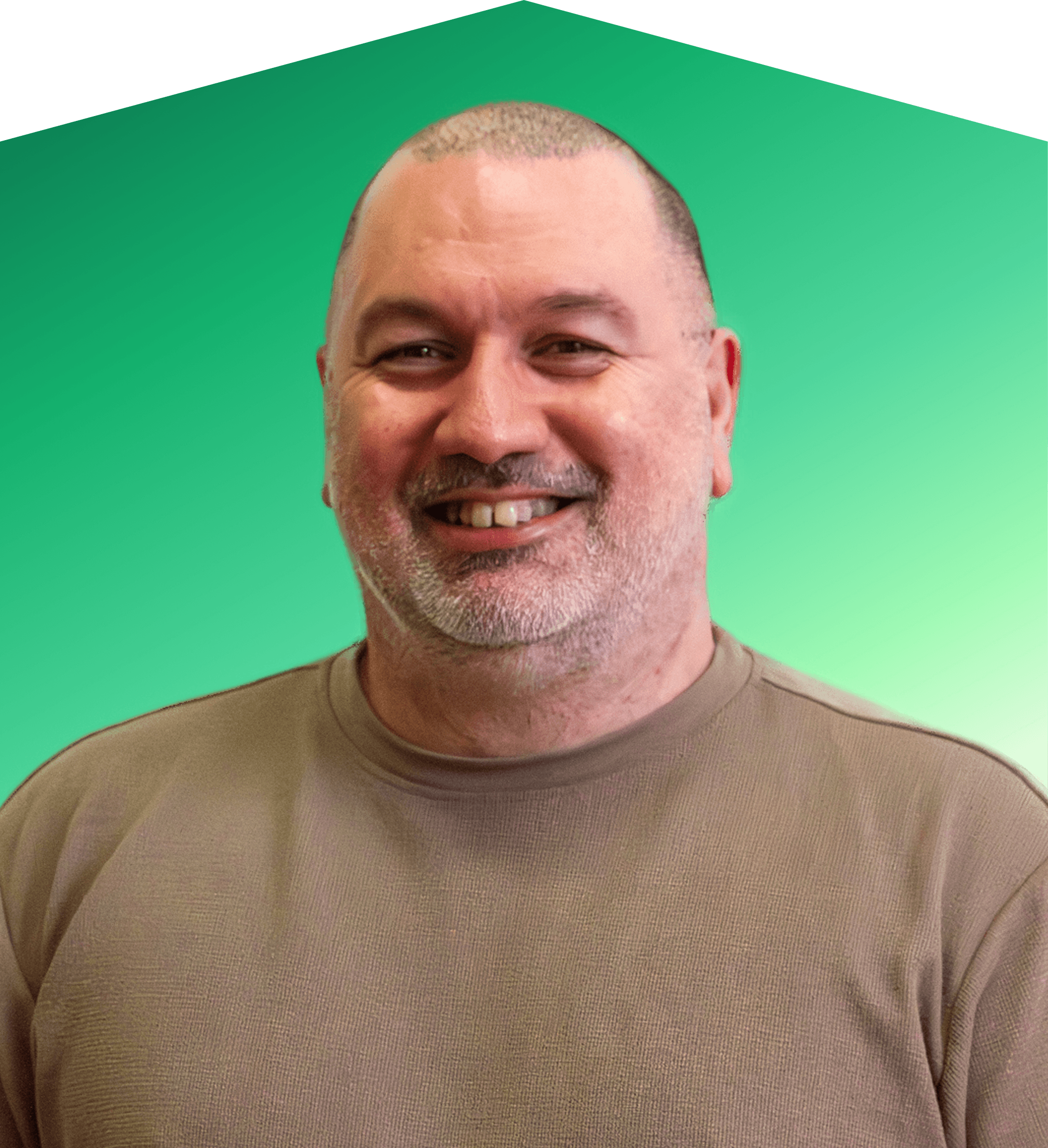 A person with curly hair smiling and holding a green background.