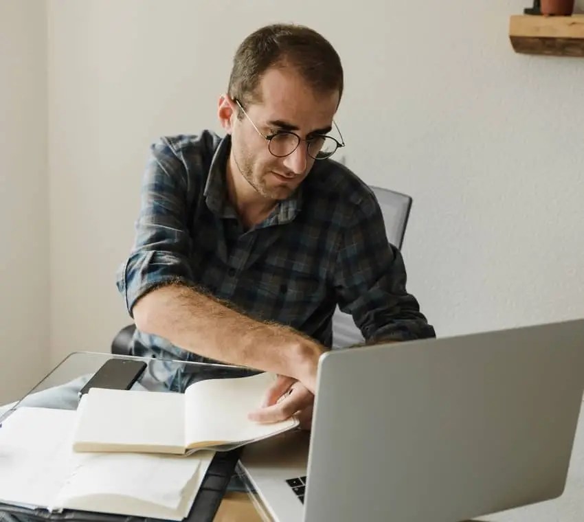 A man researching some information on his laptop.