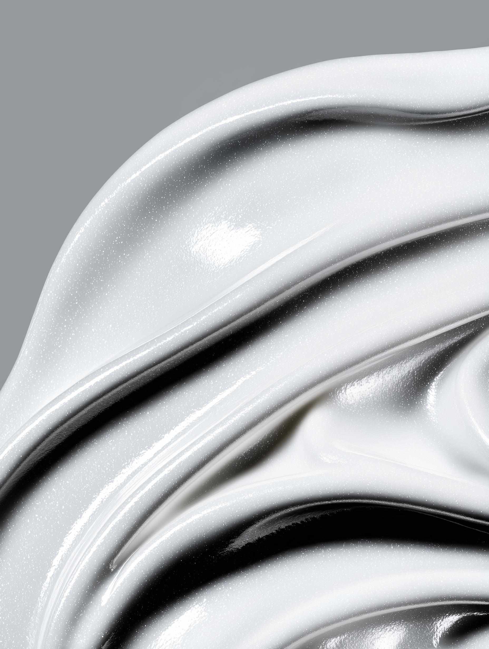 White cosmetic mousse with smooth curves and shine