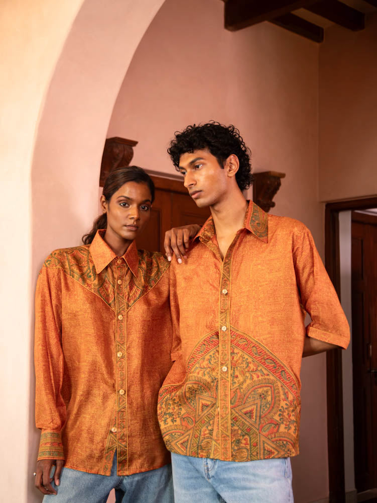 RAGA VII is a one-of-a-kind half-sleeve shirt, crafted from vintage fabric in a bold orange print with a detailed button placket, classic collar, and unique back detail.