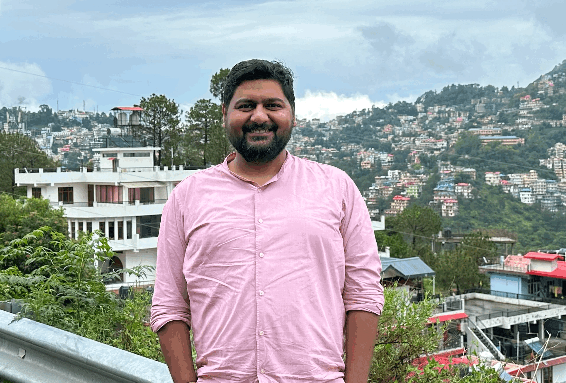 man in black suit jacket holding white ceramic mug