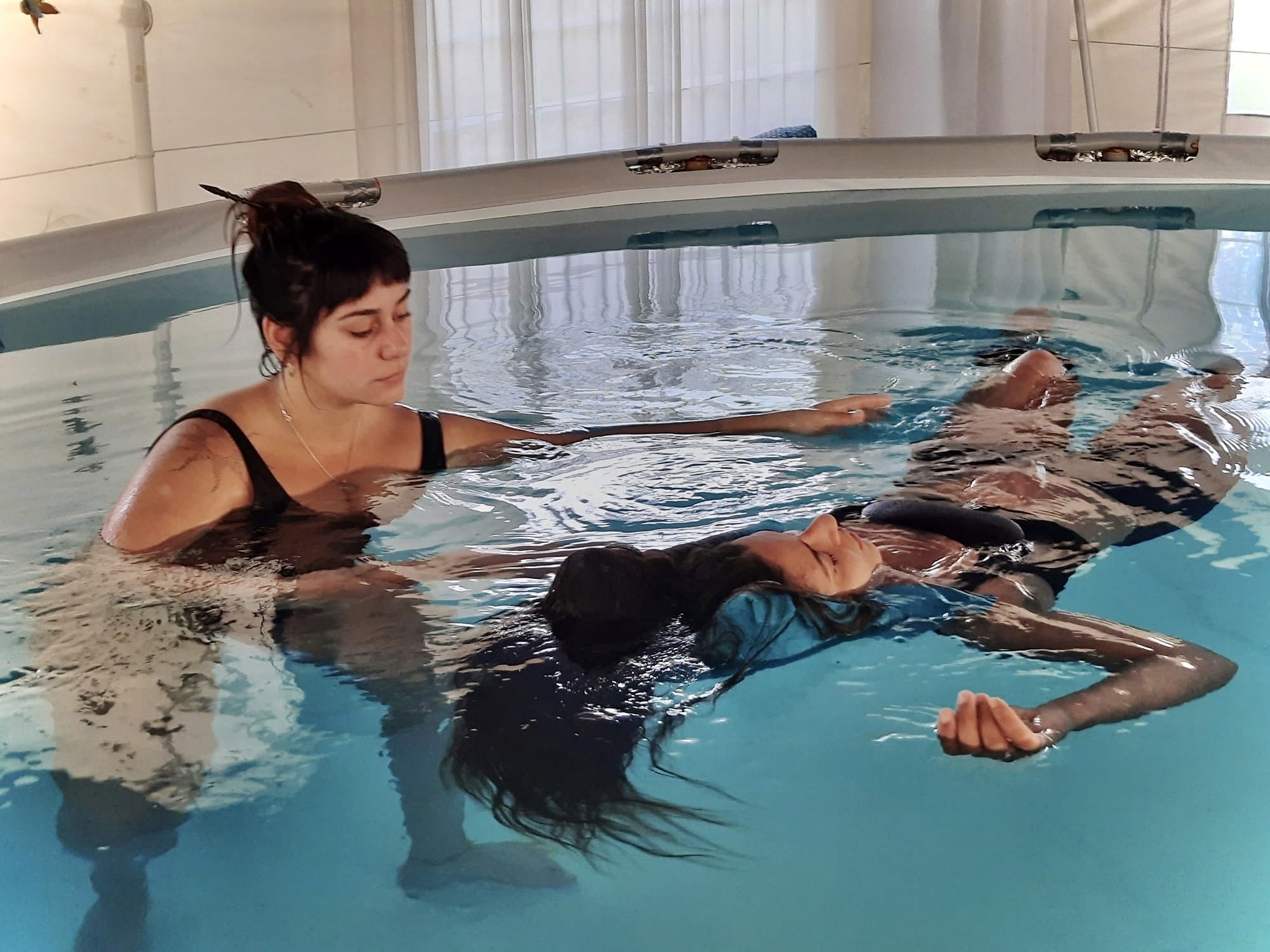 A woman receives a relaxing energy healing in a serene setting with soft lighting.