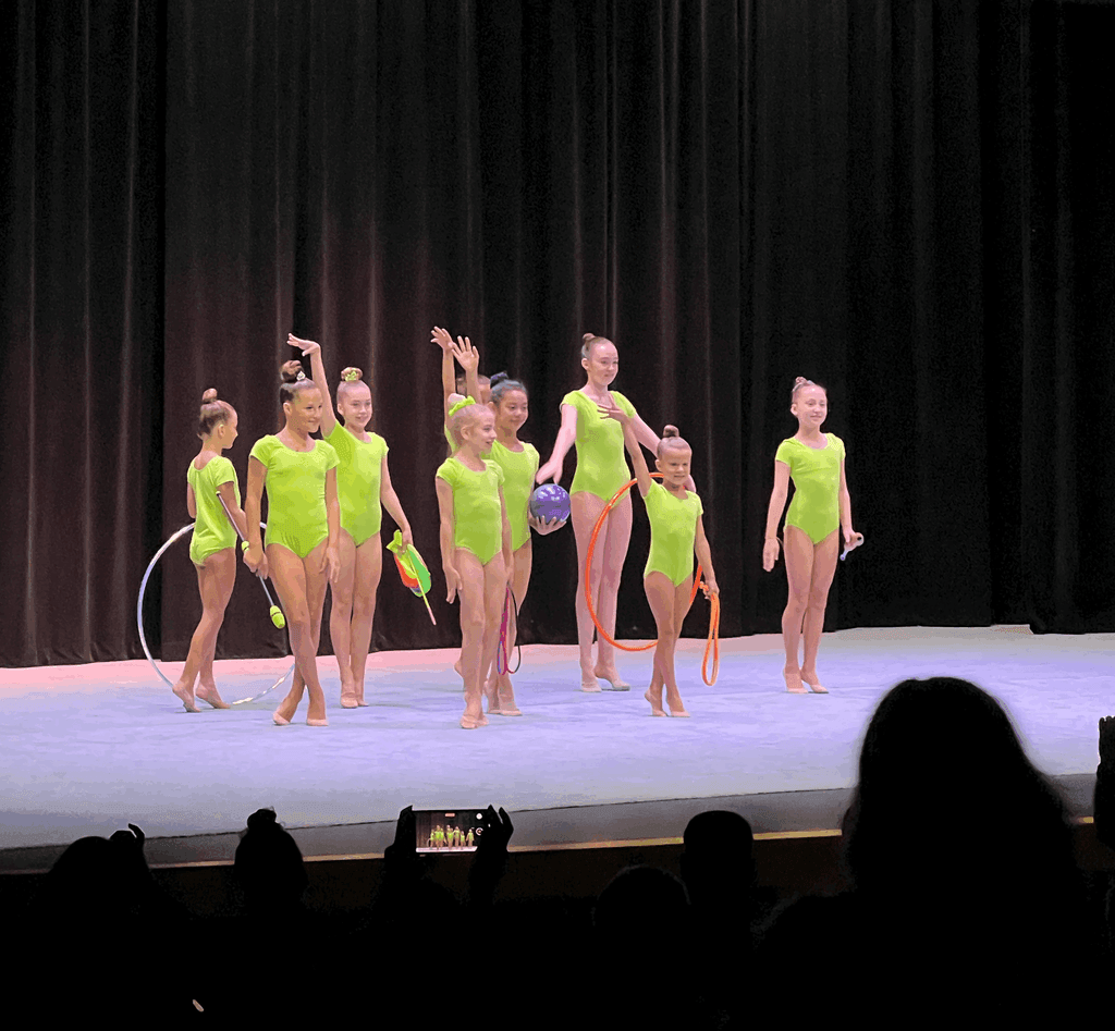 SportPlus team gymnasts perfoming on a theater stage