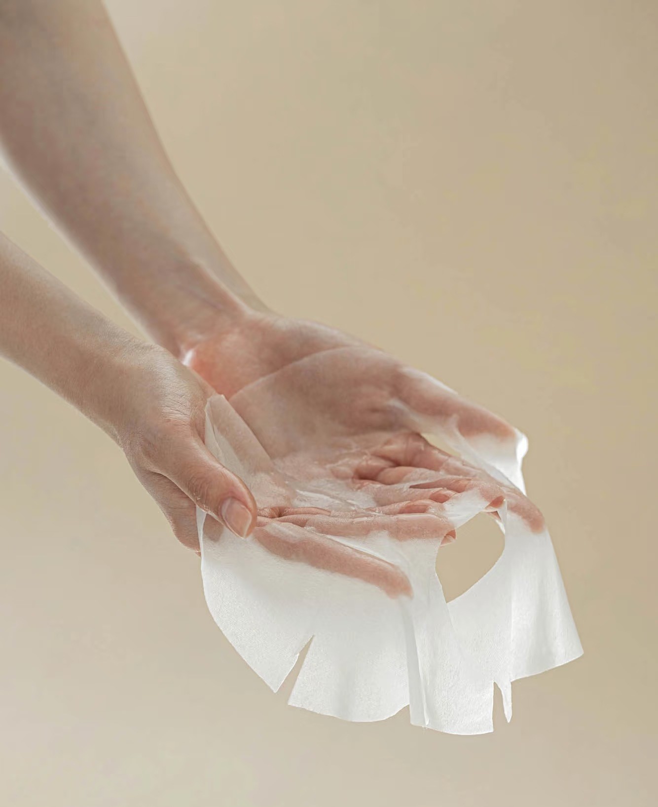 Applying moisturizing sheet mask photography by Lefty Studio