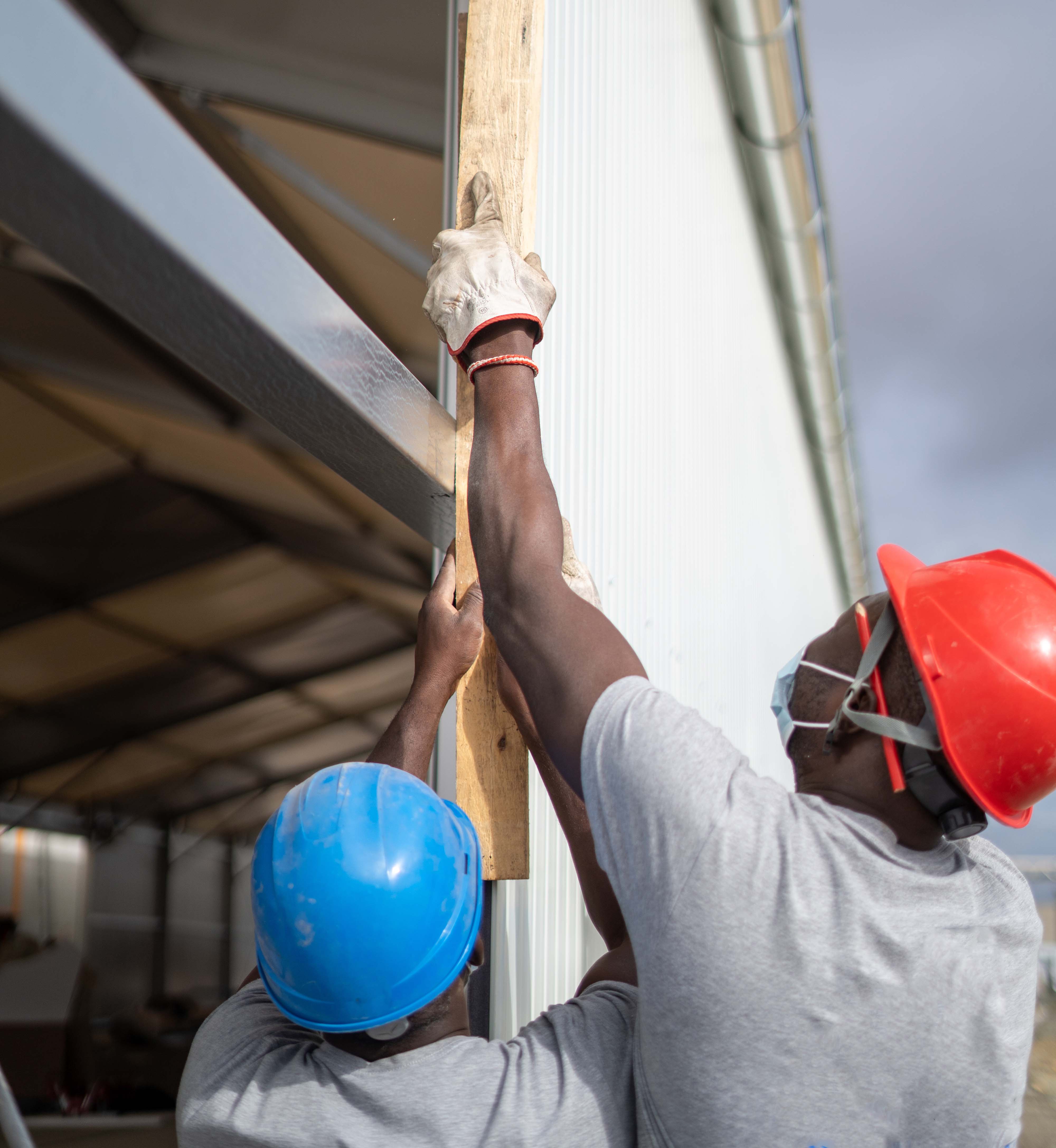 A pair of electricians working on a new construction project.