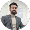 Man in blazer and turtleneck smiling