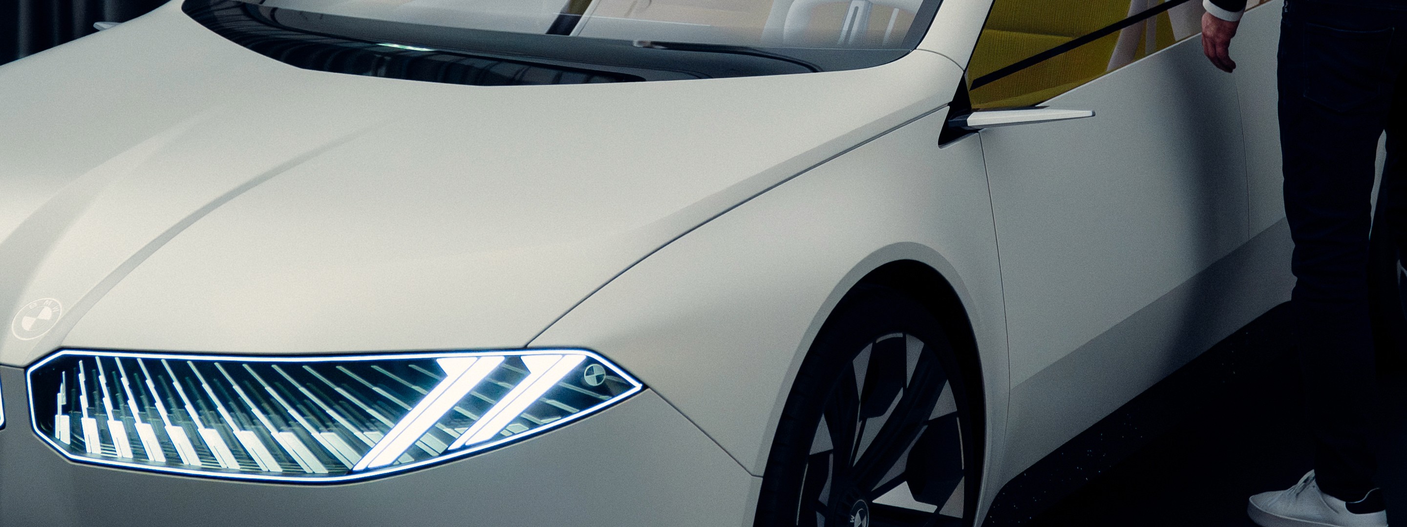 Frontal view of a car in a modern showroom with cool blue tones