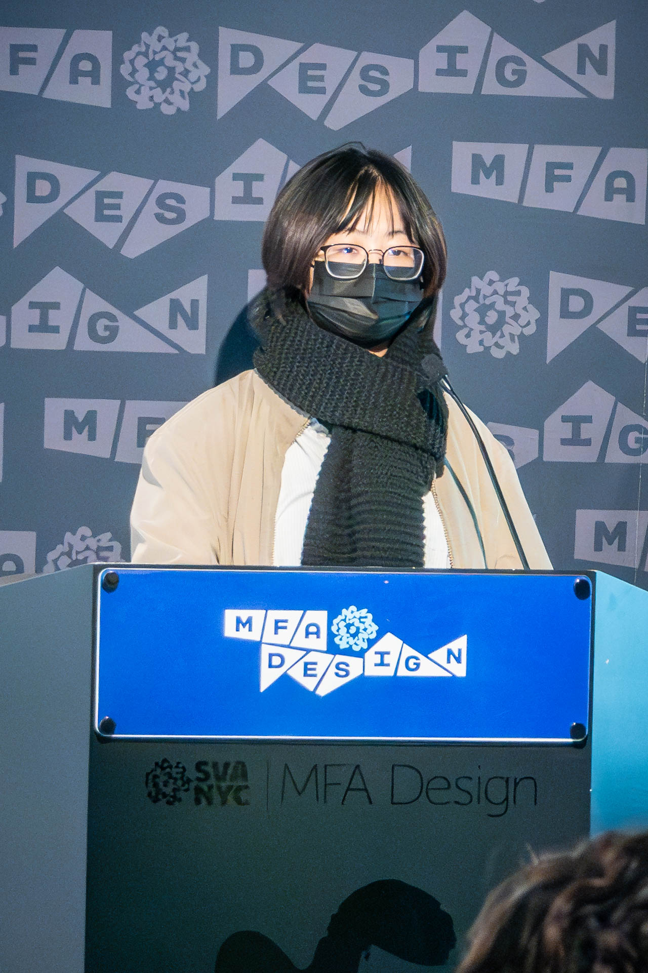student at a podium giving a presentation