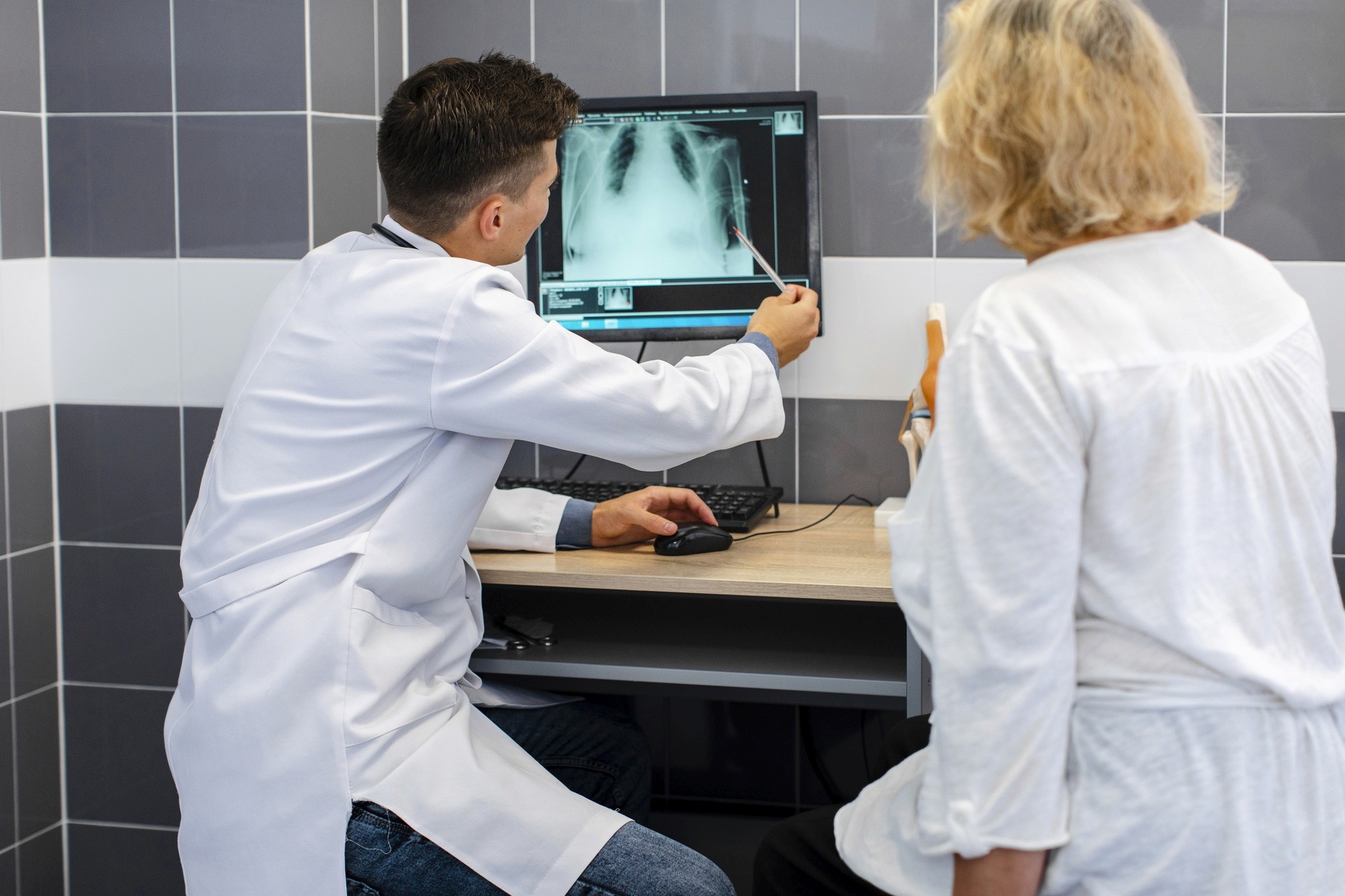 A doctor showing radiography to the other doctor for consultation.