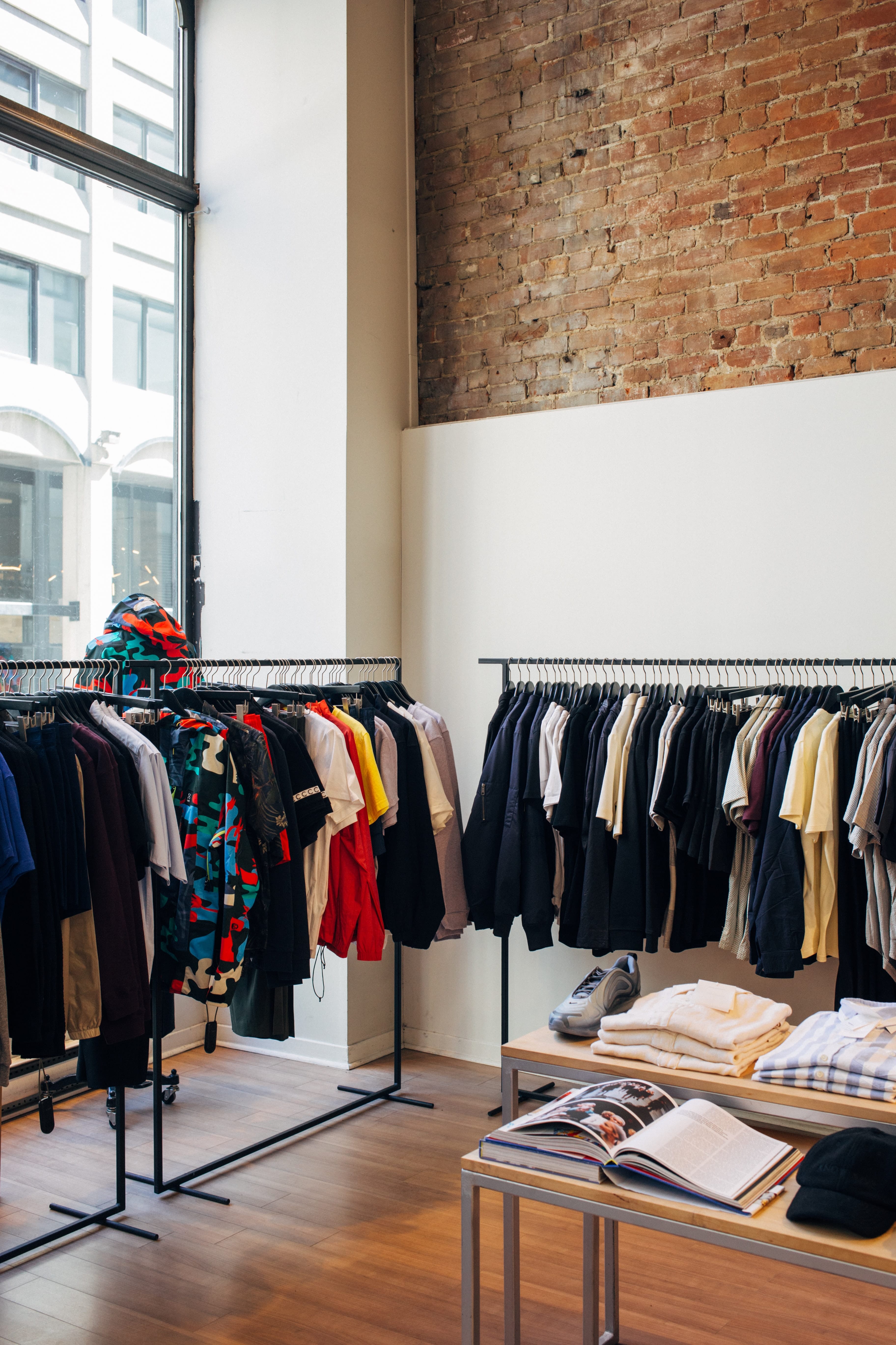 Image of a shop with clothing rails on each wall