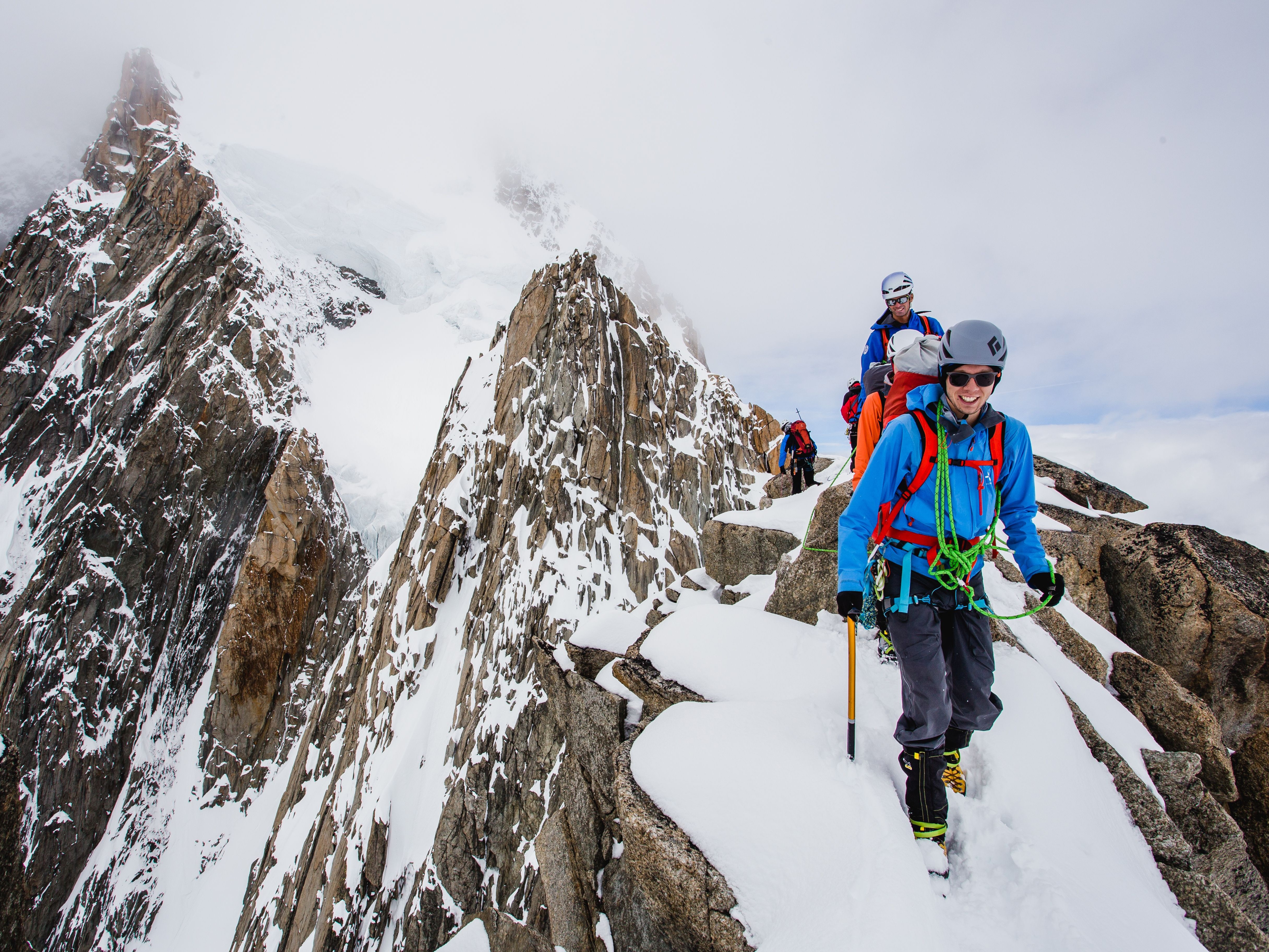 Mountaineers on a summit in the dolomites, Alpine course