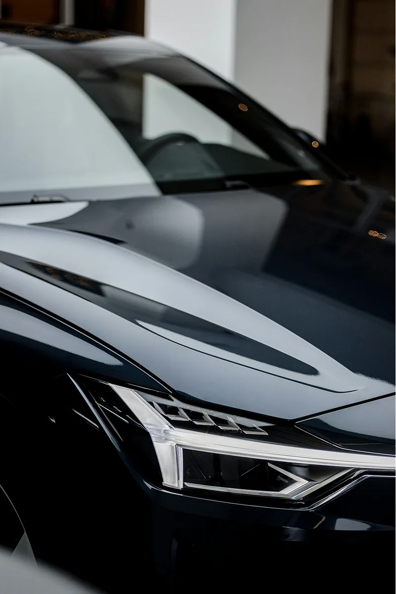 Luxury car hood with deep gloss finish and smooth protected paint surface after ceramic coating.