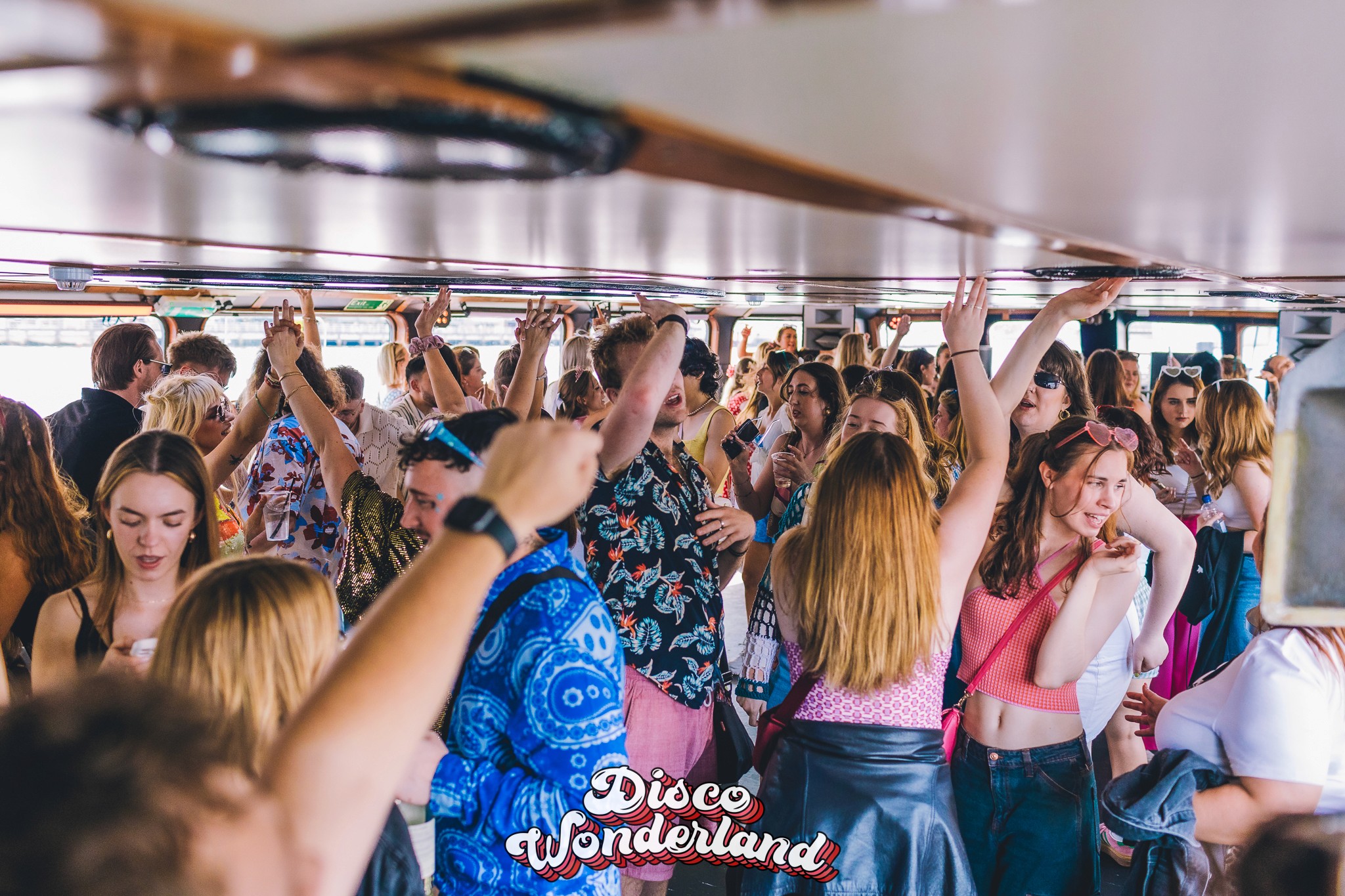 Sun-soaked open deck of the Dutch Master filled with Disco Wonderland guests dancing