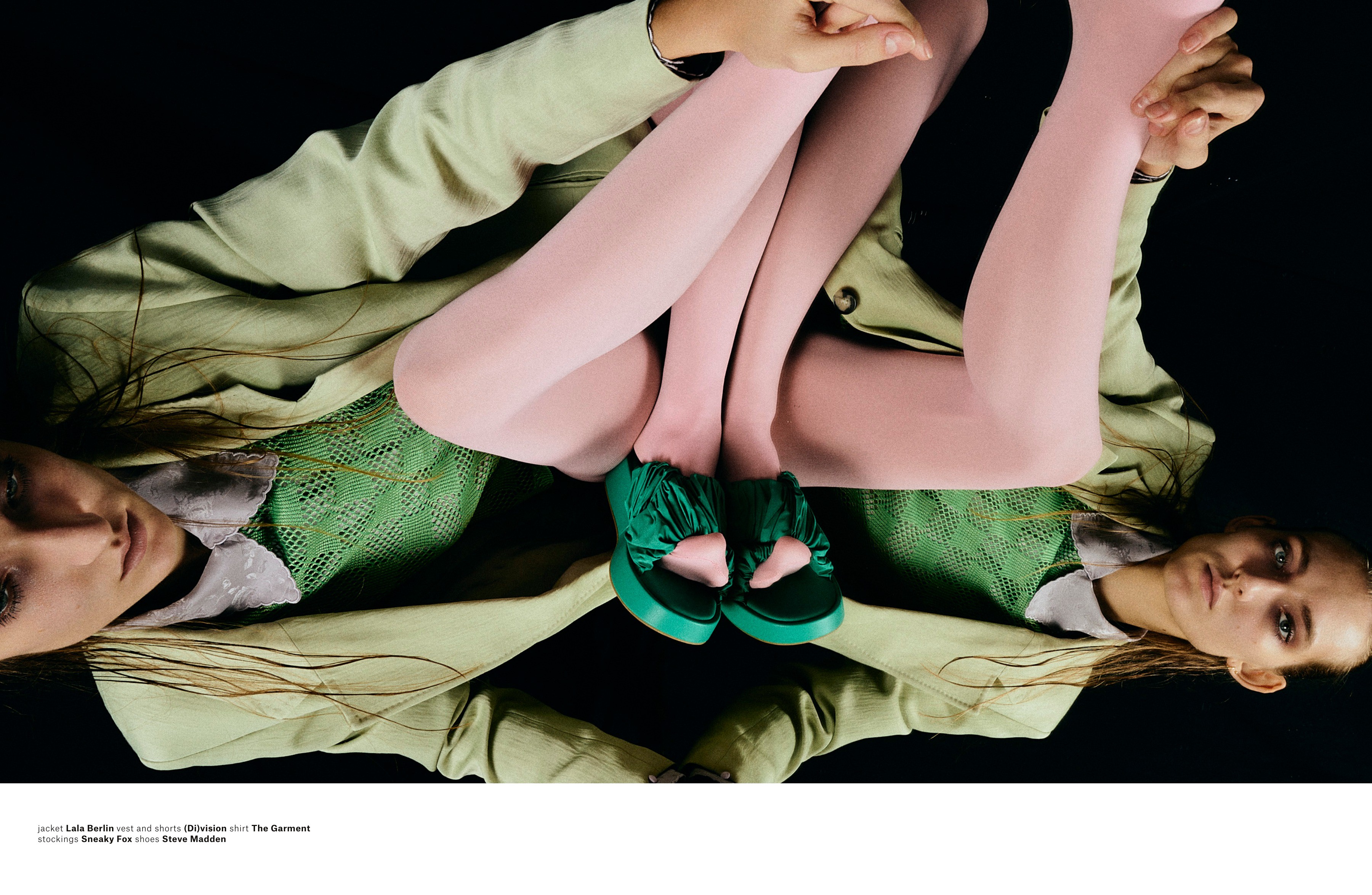 A mirrored fashion image forms a symmetrical composition across both pages.