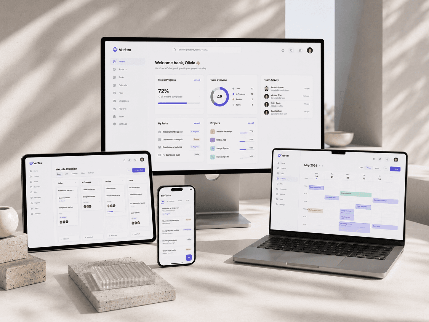 Responsive productivity dashboard presented across desktop monitor, tablet, smartphone, and smartwatch, highlighting project analytics, task management, team collaboration, and cross-device synchronization in a clean architectural workspace with soft natural light.