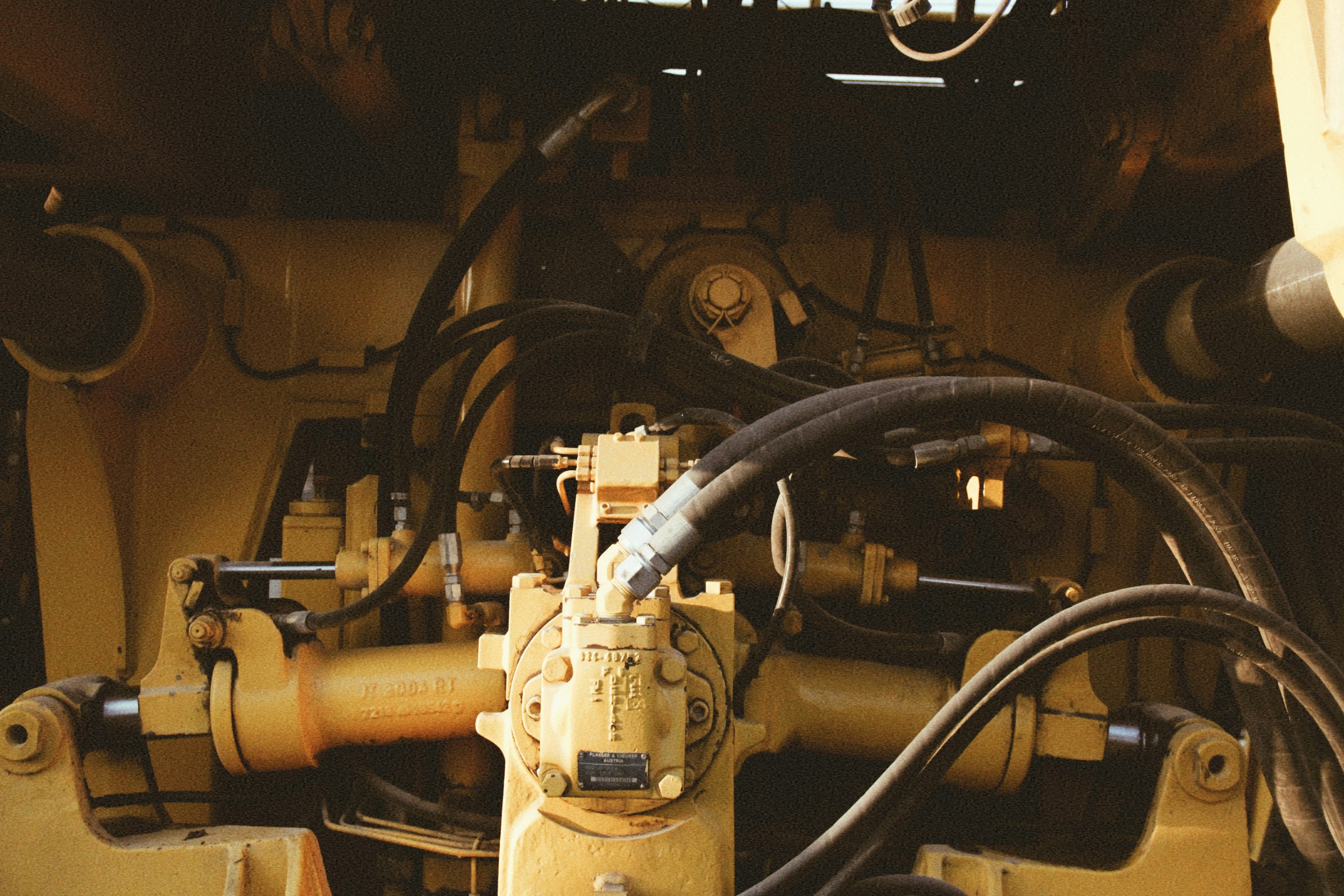 Close up detail of hydraulic lines and fittings on heavy equipment
