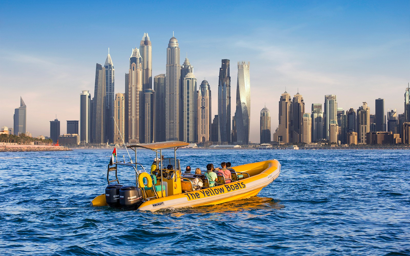 Speedboat tour in Dubai Marina with city skyline in the background.