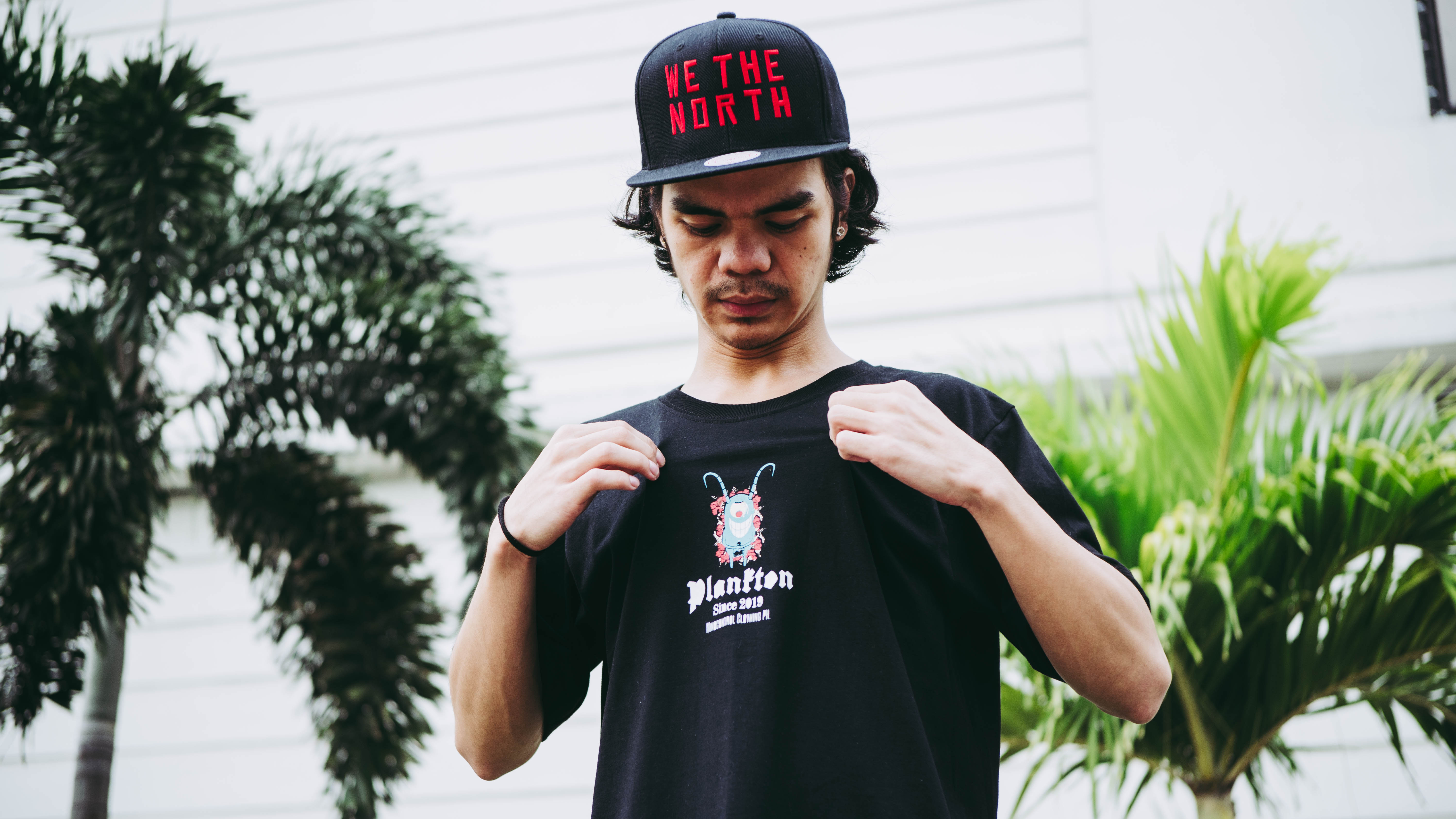 person holding black ipad with green plant